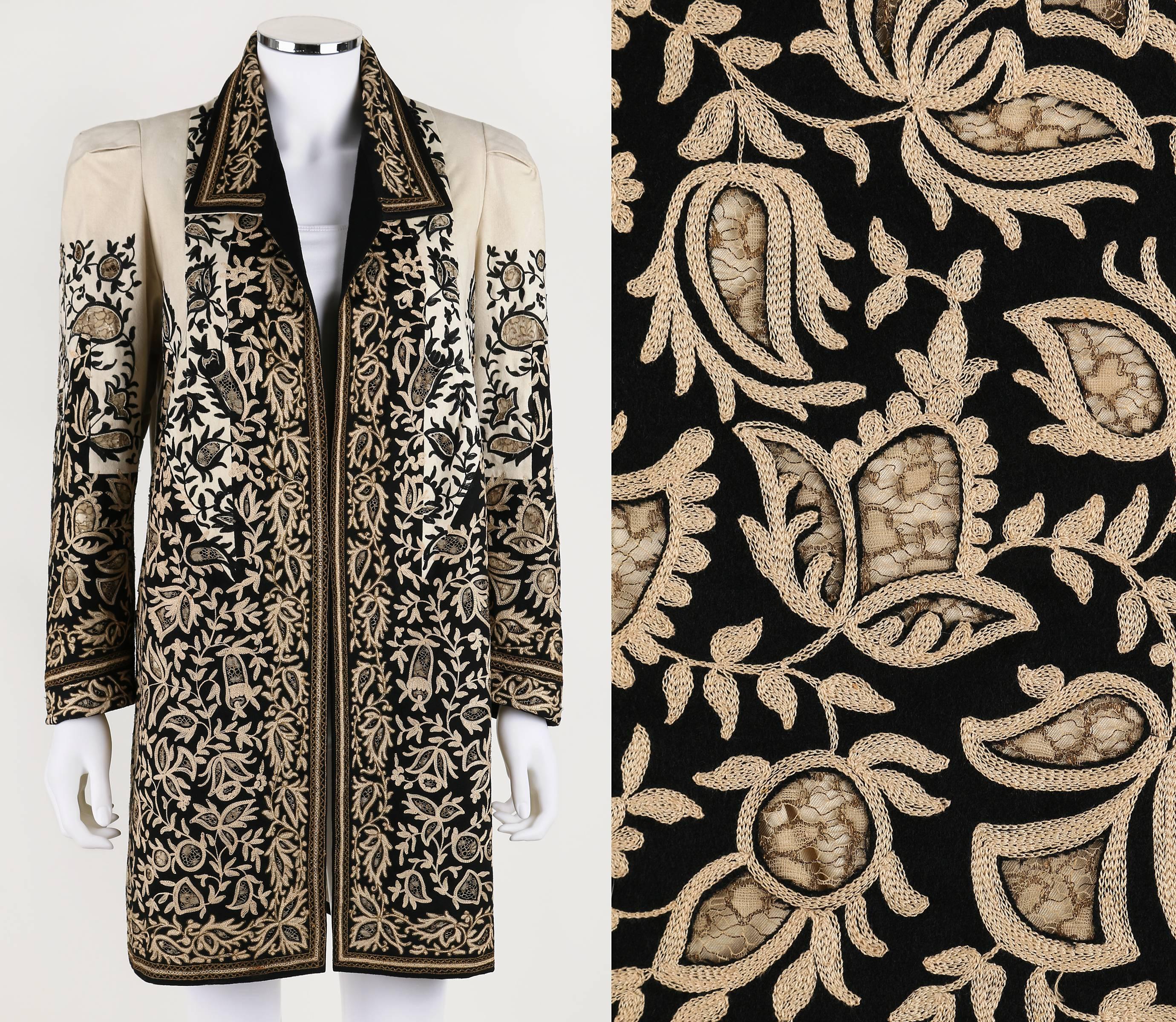 Vintage c.1910's Edwardian one of a kind couture beige and black felt coat. Intricately detailed cutwork with metallic lace insets and crewelwork and metallic embroidery detail. Long sleeve. Spread collar. Open front. Pleated/tucked detail at the