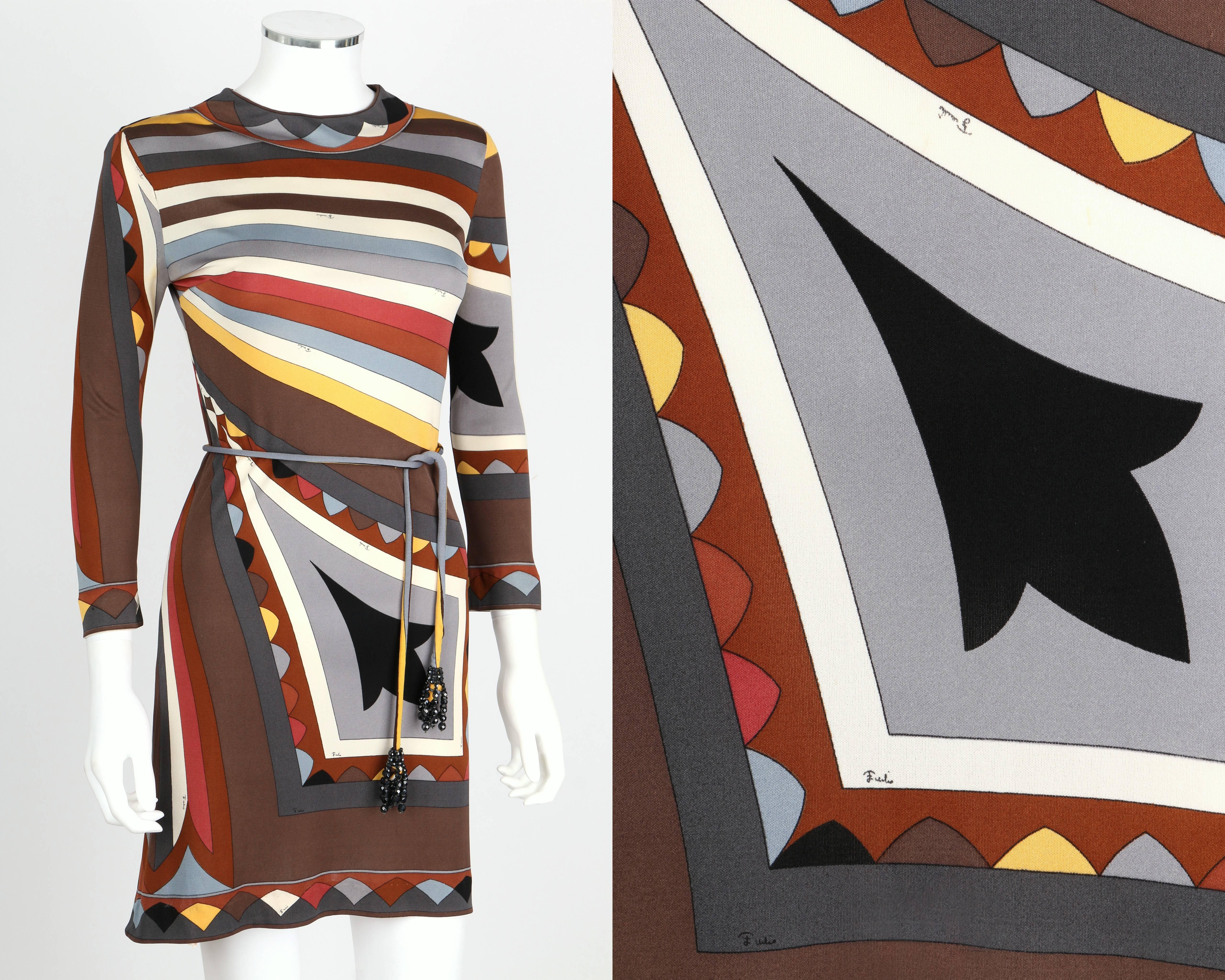 Vintage early 1960s Emilio Pucci multicolor signature print silk jersey dress. Three-quarter length sleeves. Jewel neckline. Zips at back. Matching Coppola e Toppo sash belt with beaded crystal detail. Marked Fabric Content:  