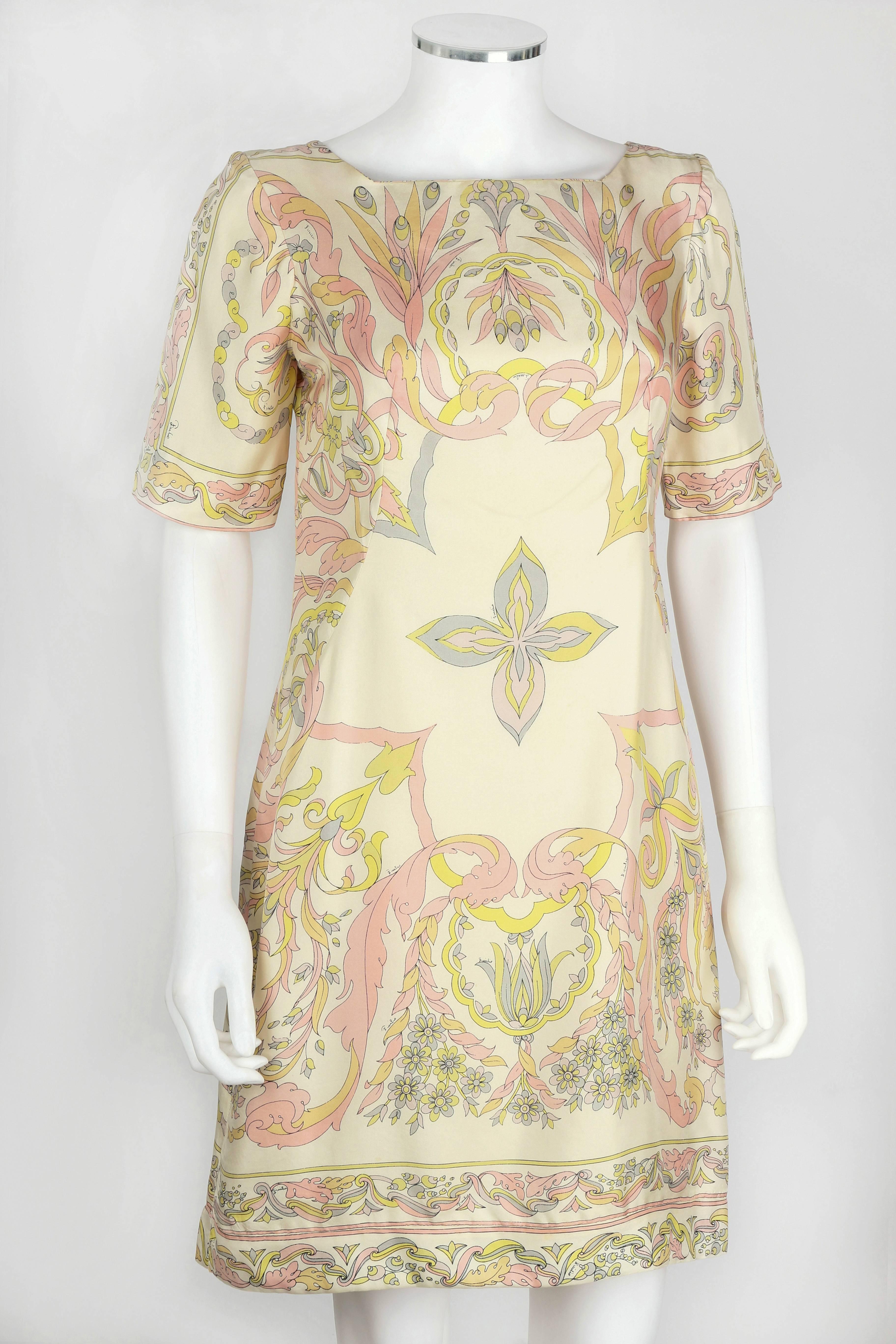 1960s Emilio Pucci Ivory silk shift dress with a pastel art noveau/baroque inspired floral scrollwork print. Short sleeves. Zips at side. Lined. Please note that this item was clipped to better fit our mannequin for photographs. Marked Fabric