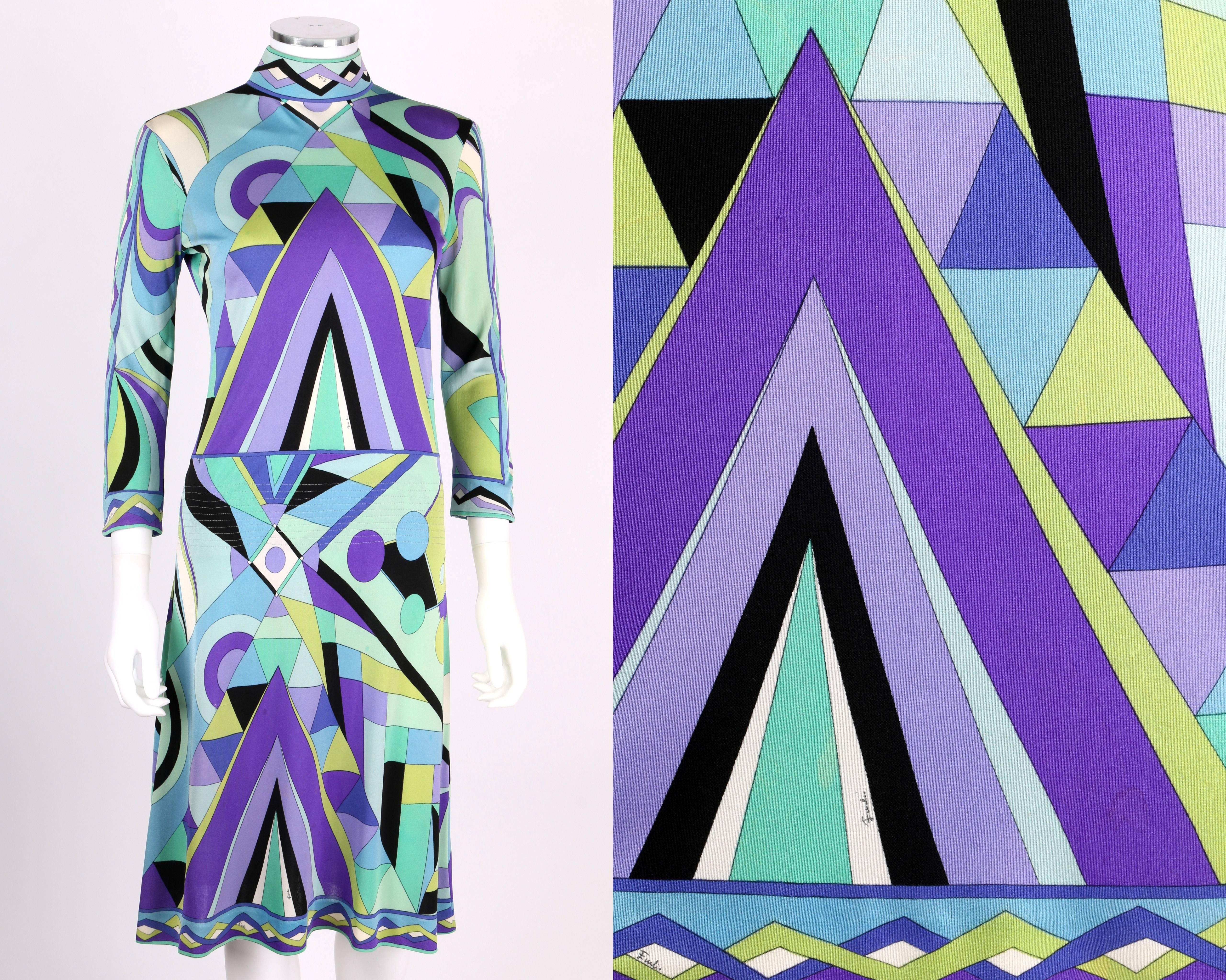 Vintage c. 1960s Emilio Pucci silk jersey A-line knee length dress. All over signature print in green, purple, blue, black and white.  High mock neck collar. 3/4 length sleeves. Quilted detail at hips. Center back zipper. Marked Fabric Content: 