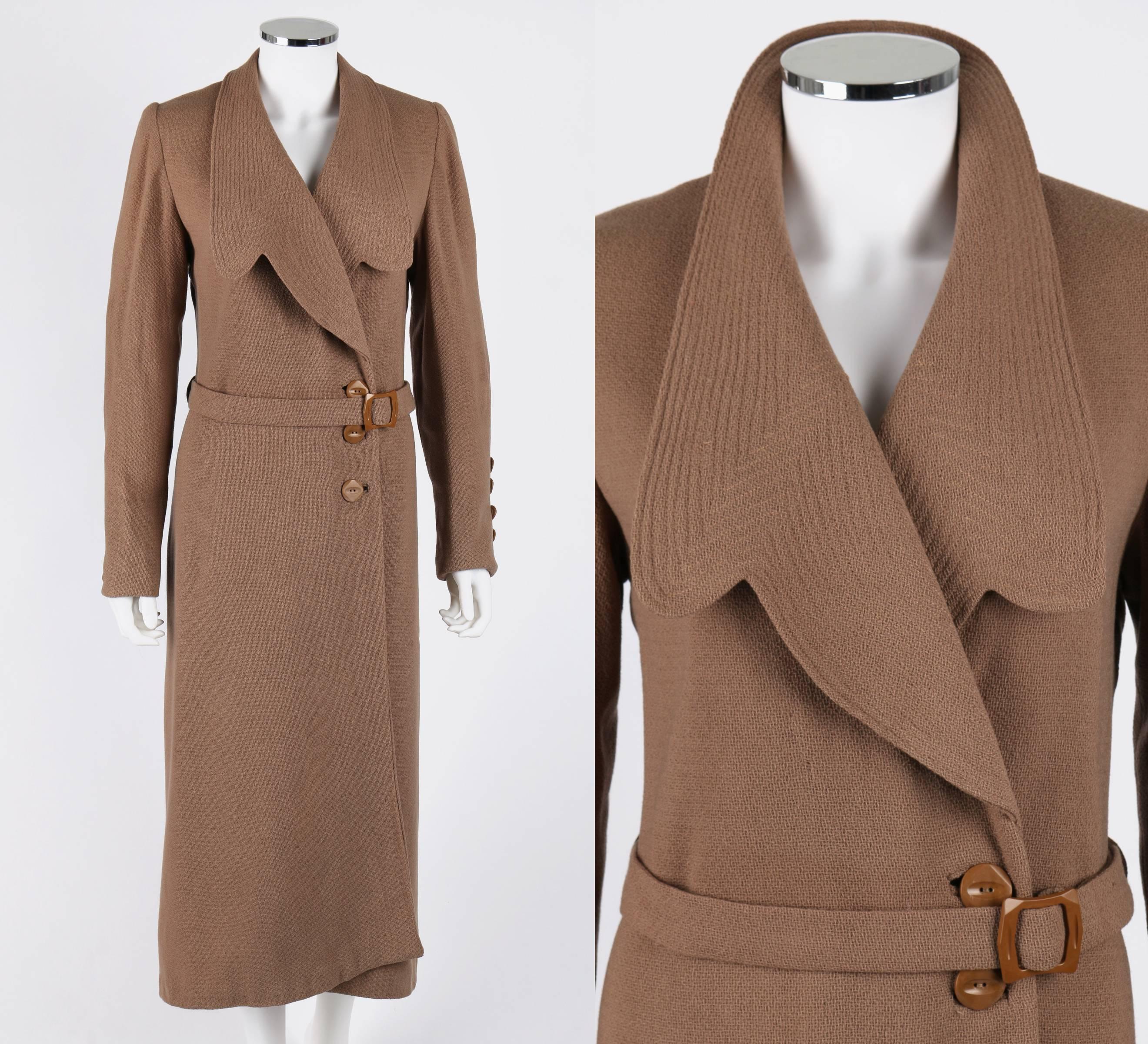 OOAK Vintage 1900s-1910s Edwardian tan long coat. Large notched lapel with topstitching. Long sleeves with pintuck detail. 5 buttons on cuff. Center front three-button closure. Princess seams at back. Two belt loops. Long belt with buckle. Unmarked