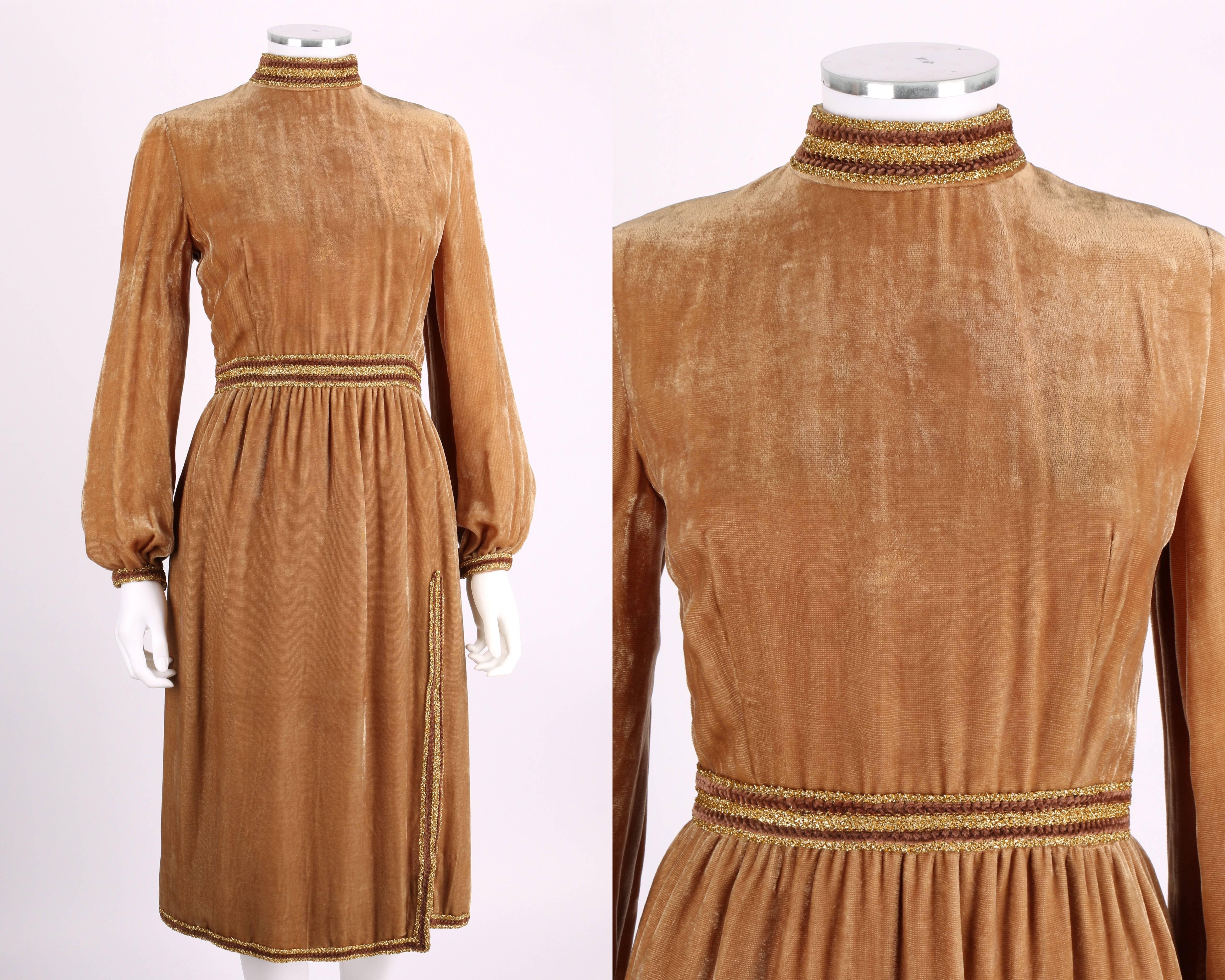 Vintage late 1960s Oscar de la Renta tan/gold/bronze velvet dress. Gold metallic and brown trim. High mock neck collar. Long bishop sleeves snap at fitted cuffs. Skirt has off-center slit at the front and back. Two pockets. Zips center back. Thinly