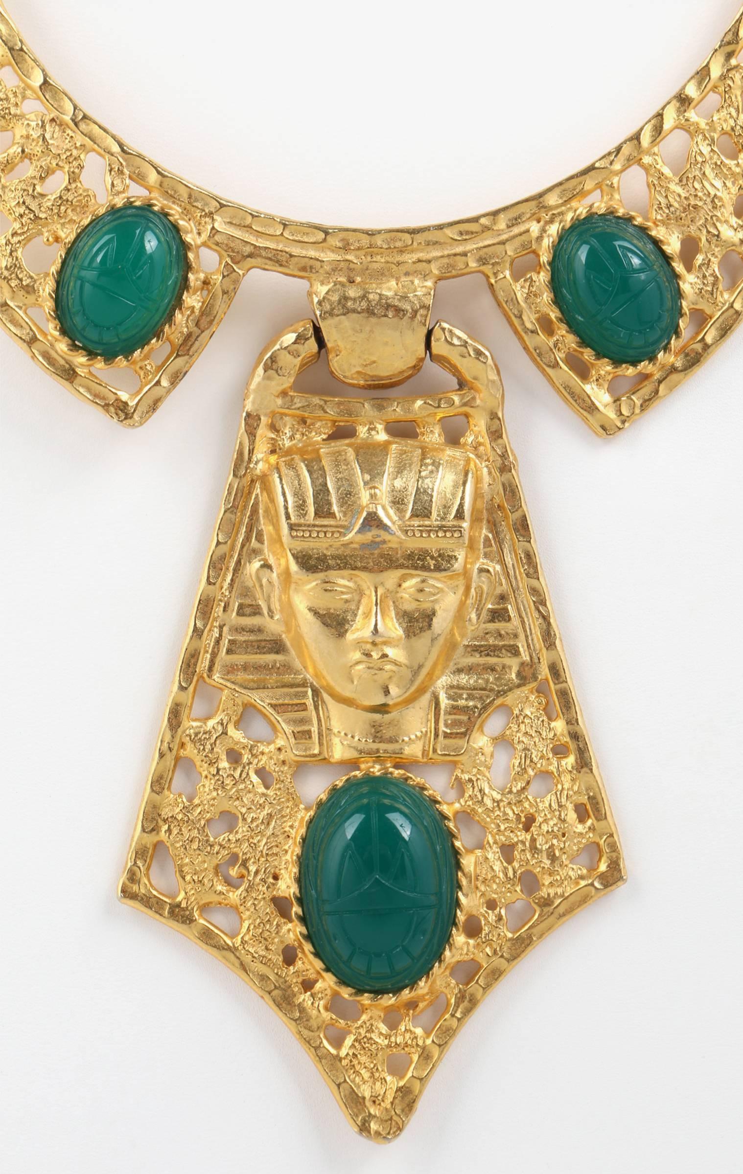 Vintage c.1960s Hattie Carnegie large Egyptian Revival gold-tone necklace with three green scarabs. Collar/bib style with two scarabs set in gold tone open work metal (scarabs measure approximately 3/4