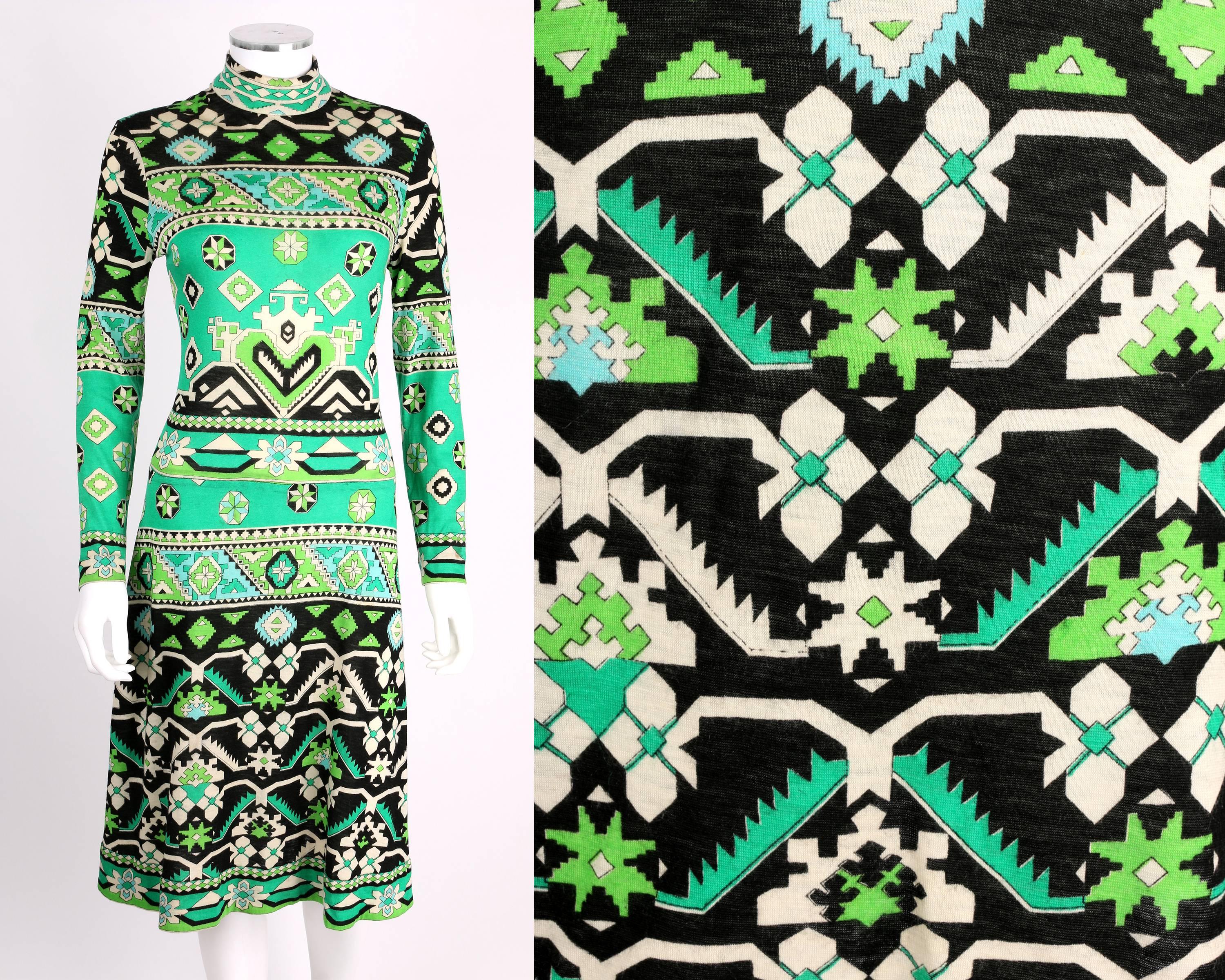 Vintage late 1960s Leonard Paris cashmere jersey dress with geometric tribal/floral print in shades of green, black and off-white. Mock neck collar. Long sleeves. Knee length. Zips at center back. Please note that this item was pinned to better fit