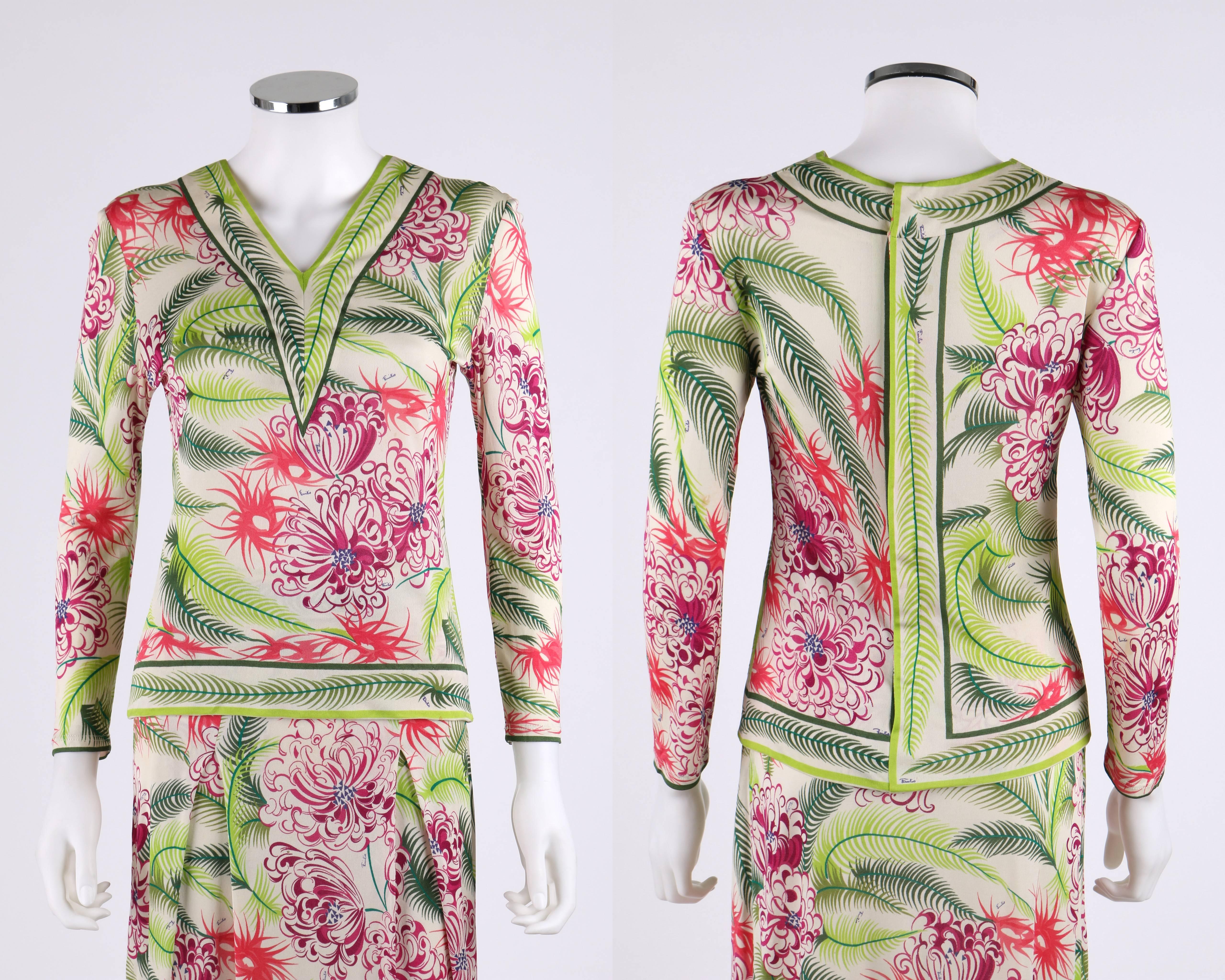Vintage 1960's Emilio Pucci two piece multi-color tropical floral palm / fern print blouse and skirt. Long sleeve top has v-neckline. Center back zipper with snaps. A-line skirt. Two inverted pleats at front. Size zipper closure. Waistband has hook