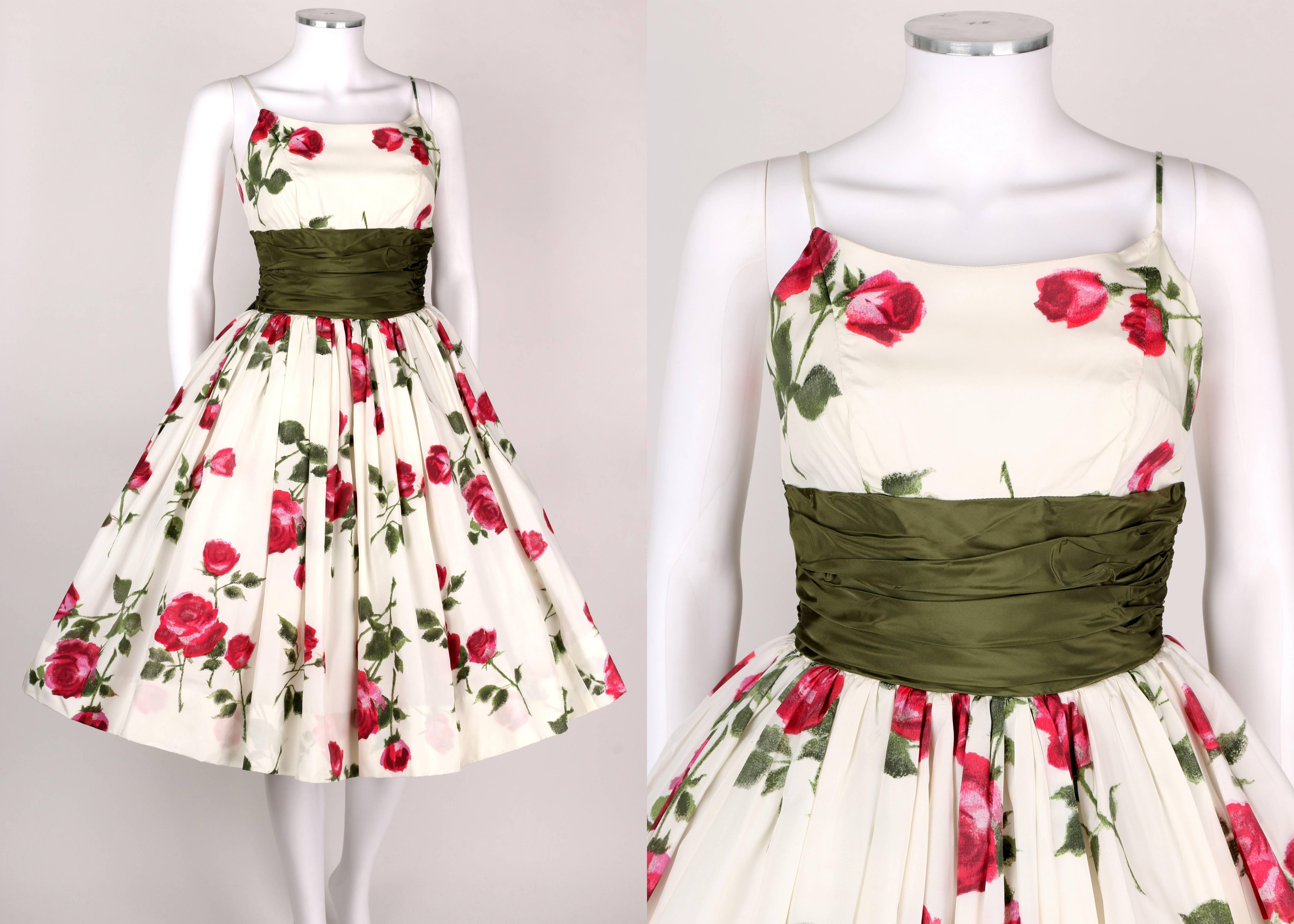 Vintage c. 1950s white, green and magenta pink rose print taffeta party dress. Spaghetti straps. Tea length. Wide olive green taffeta attached cumberbund sash with large bow at back. Skirt has layered lining of tulle, taffeta and crinoline for