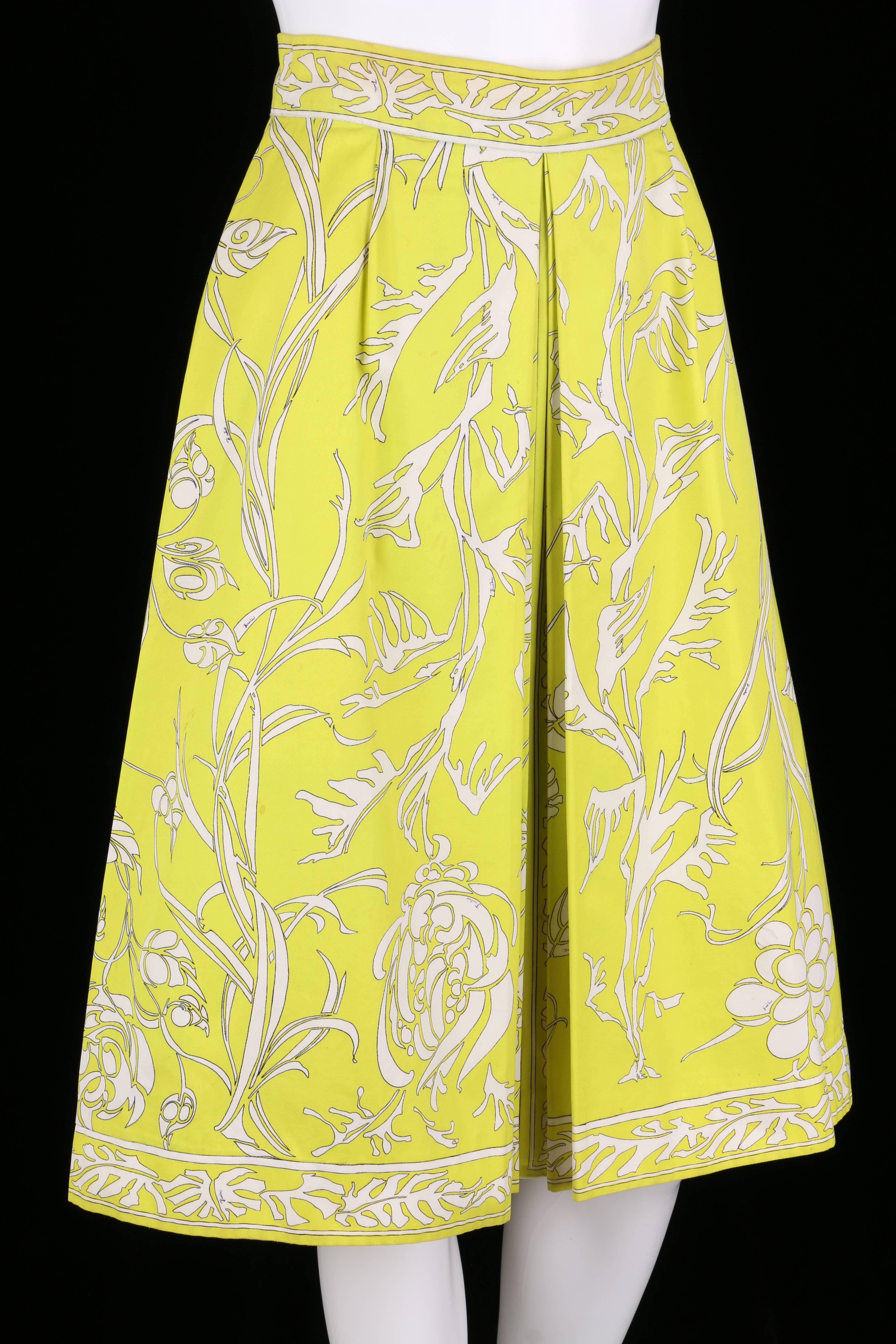 Vintage c.1970s Emilio Pucci chartreuse and white floral print cotton skirt. Center floral motif with fern decorative border. Inverted pleat detail at front. Knee length. Closes at hip with zipper and hook/eye. Please note that this item was pinned