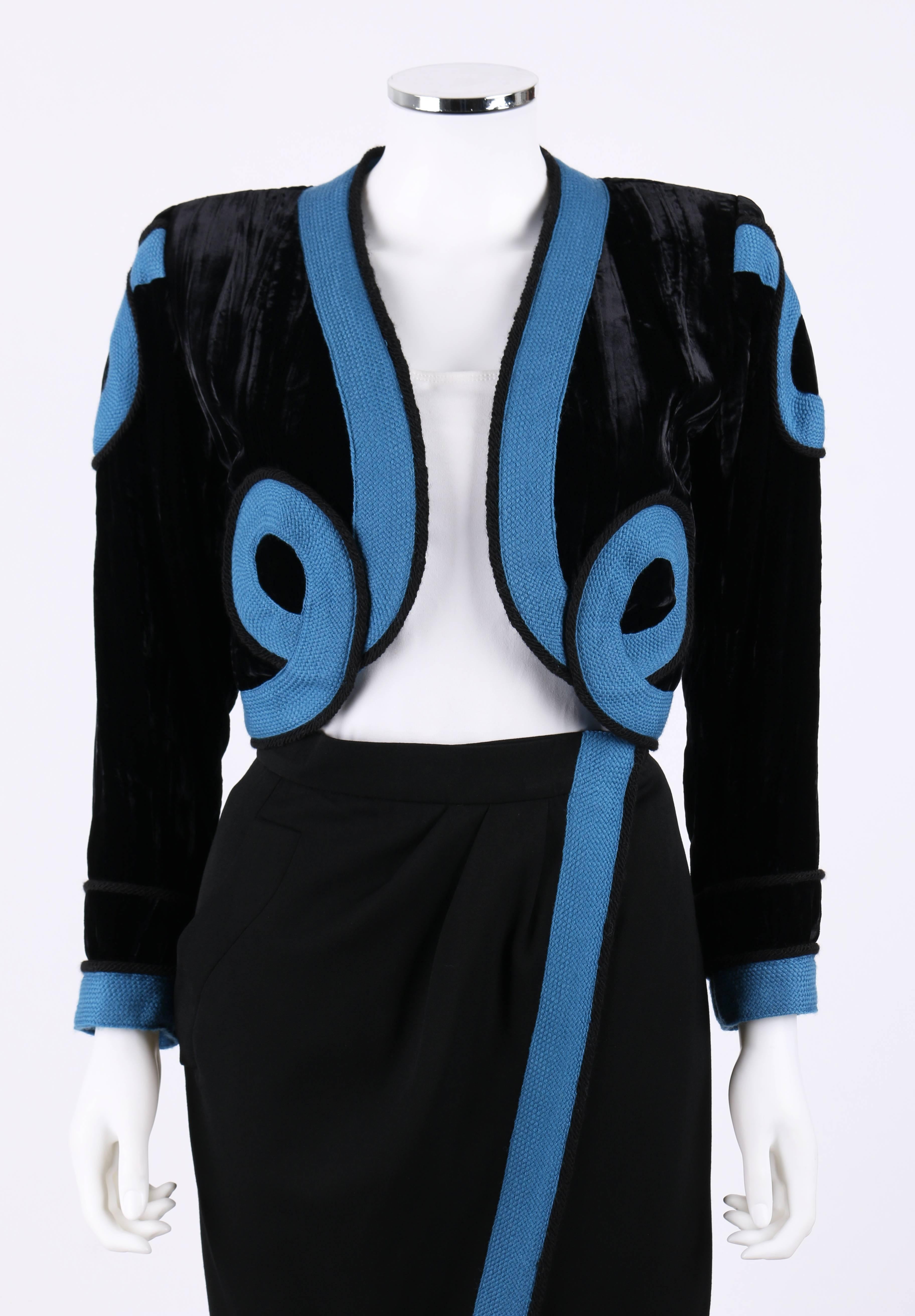 Vintage S/S 1990 Yves Saint Laurent Toreador-style two piece black 100% wool skirt and silk velvet blazer set. Long sleeve. Open front. Blue and black woven rope embellishments on blazer center front, shoulders, cuffs and center front of skirt.