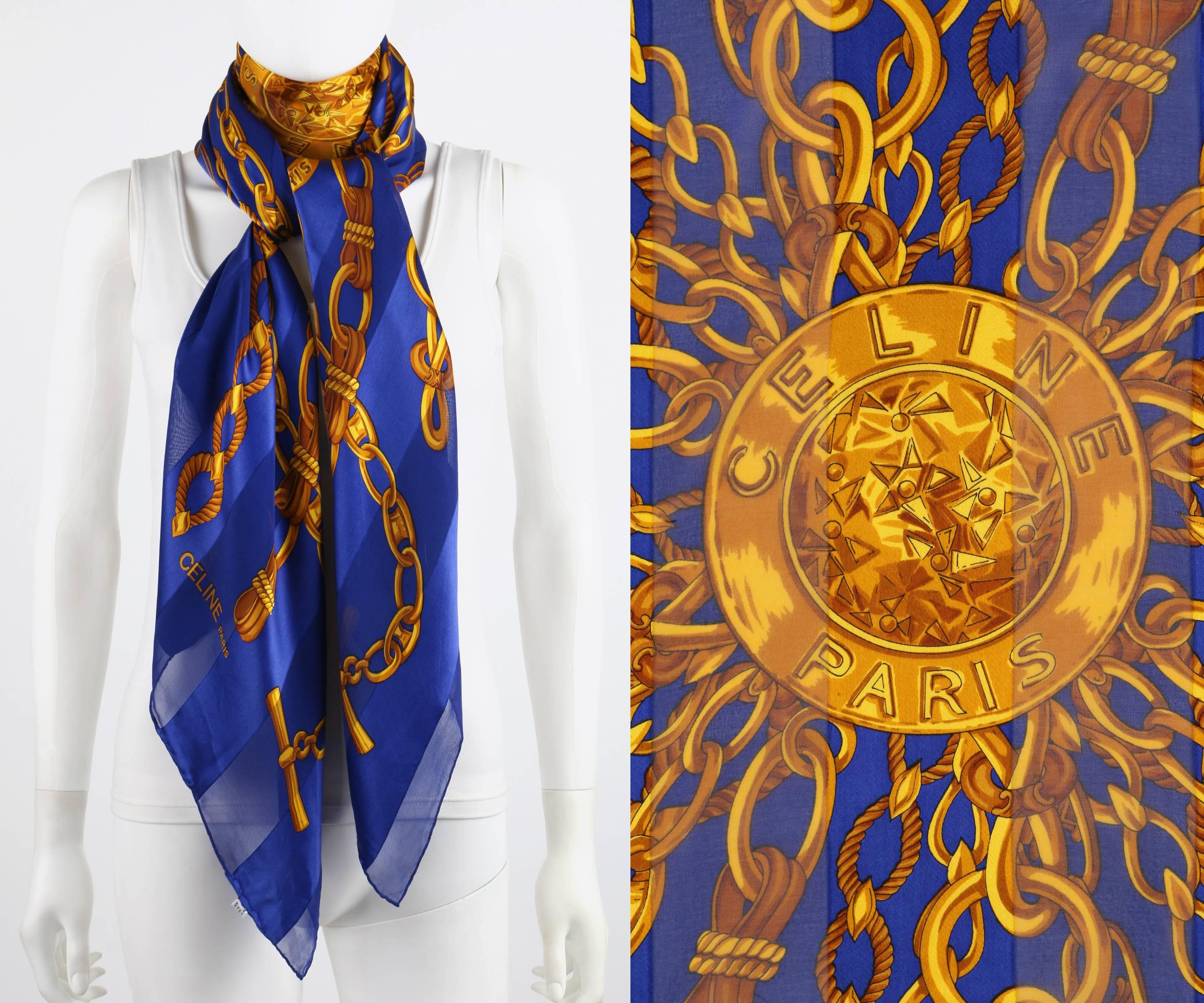 Celine 100% Silk scarf. Blue opaque and translucent striped background. Center gold medallion with 