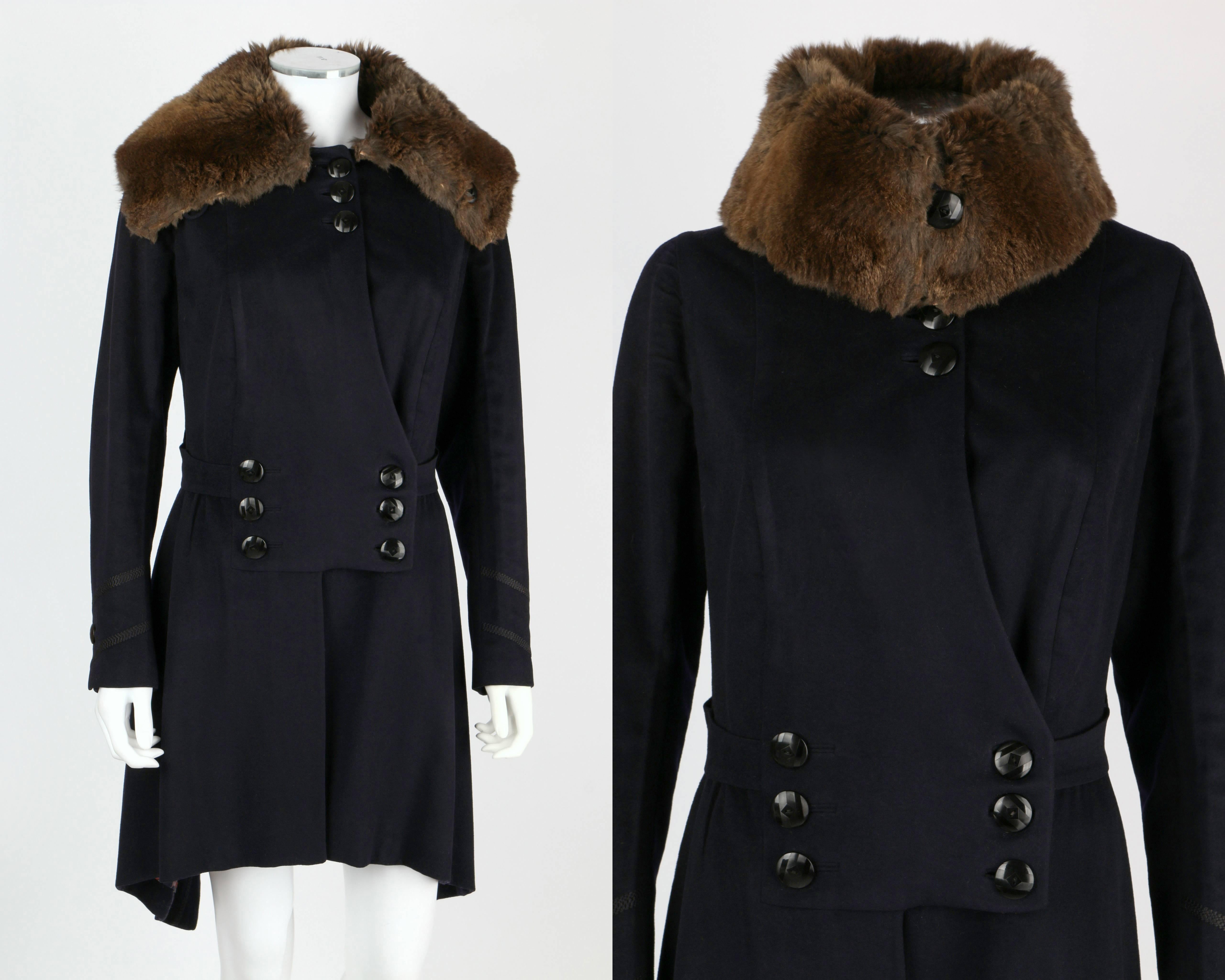 Couture c.1910's navy blue wool coat. Military inspired trim. Double breasted button front with cut away detail. Panel detail at sides. Large fur collar. Lined in purple, navy and coral polka dot silk. Please note that this item was pinned to better
