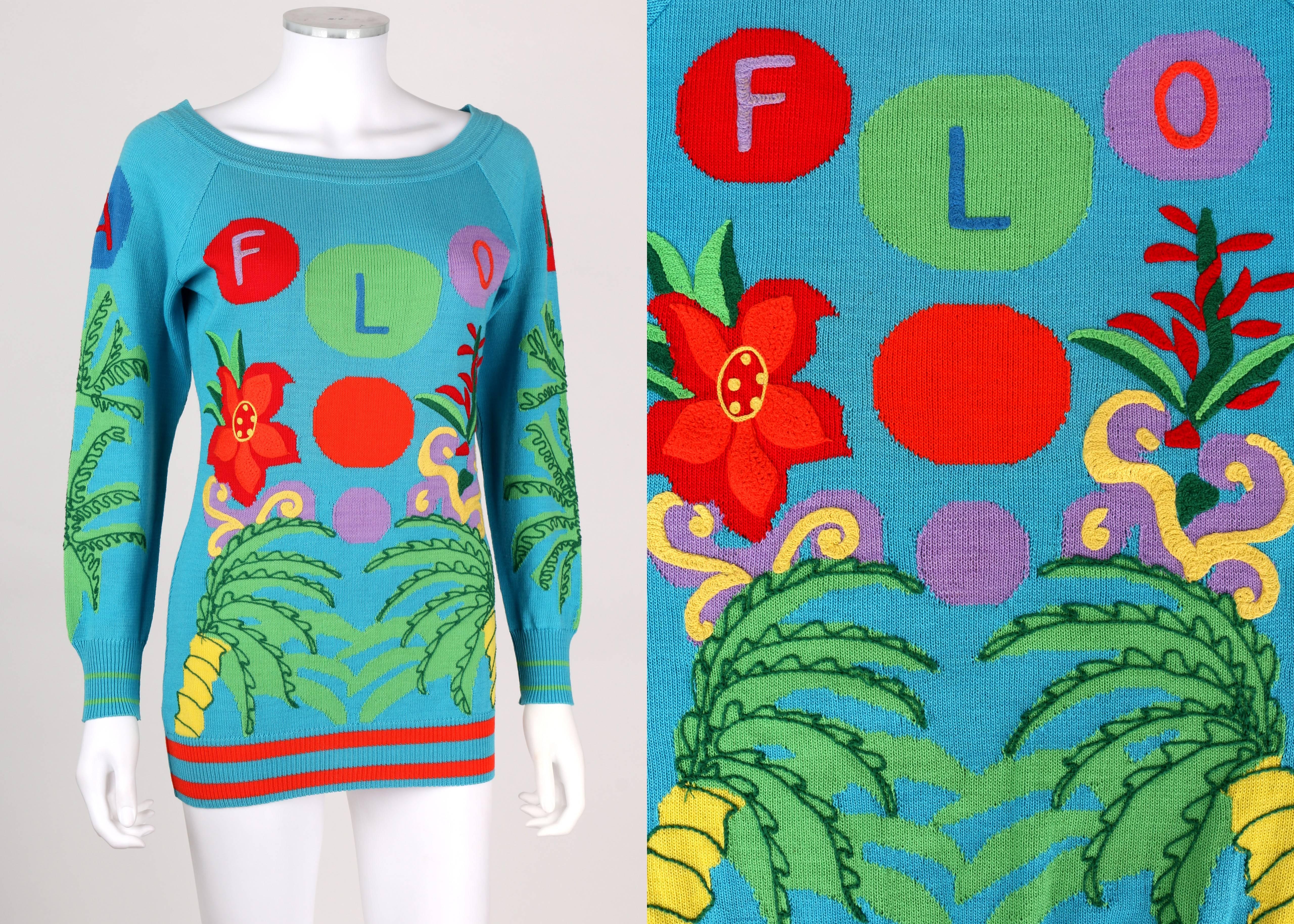 Vintage Spring/Summer 1993 Gianni Versace blue Florida palm tree print wool multicolor embroidered sweater. Bateau neckline. Long raglan sleeves. Ribbed at collar, cuffs, and hem. Striped detail at cuffs and hem. Pullover style. Marked Fabric: 