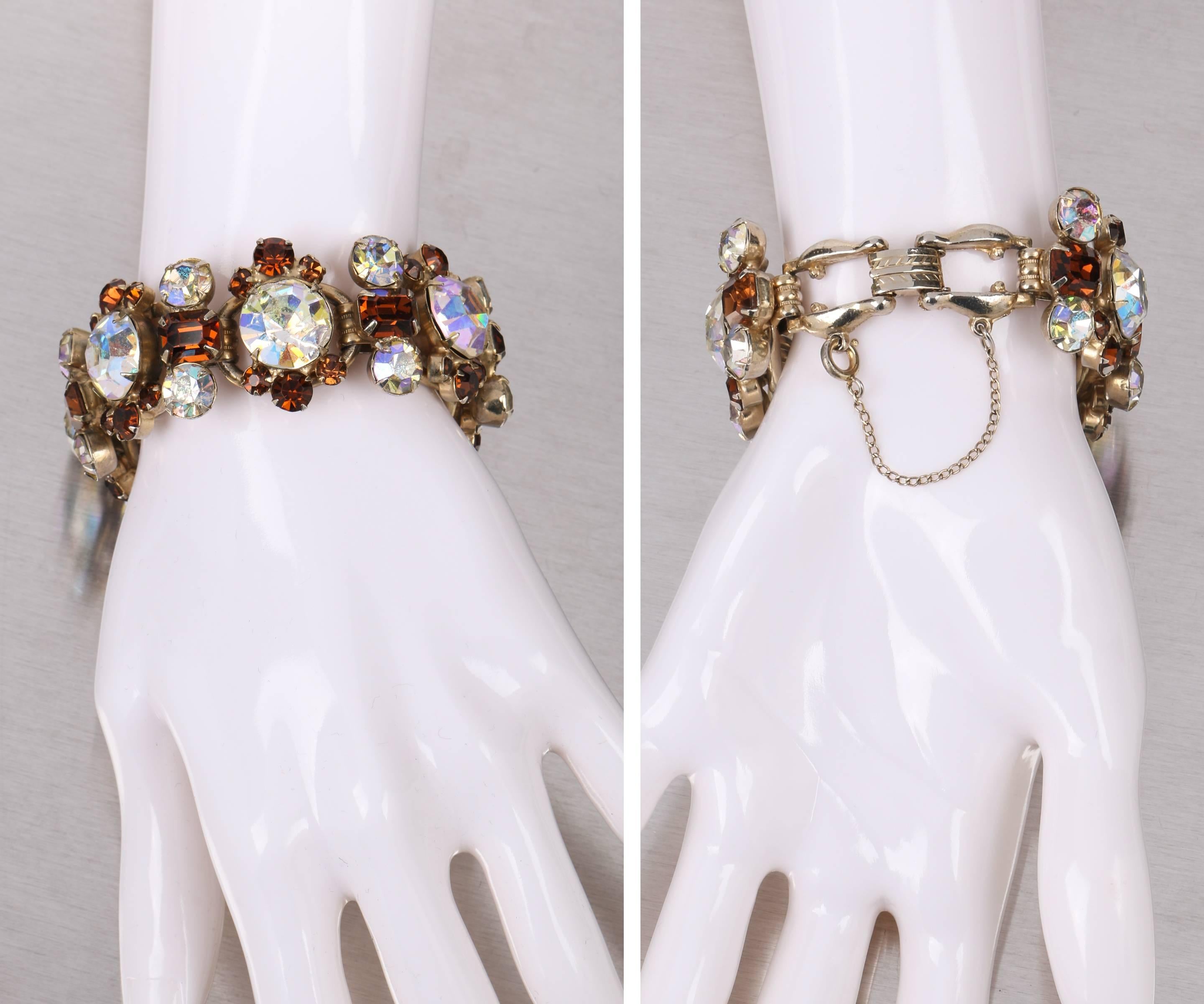 Vintage c.1950's Juliana Delizza & Elster chunky gold tone metal chain bracelet with large rhinestones. Five large (14mm) aurora borealis clear faceted rhinestones set with 6 smaller round amber colored rhinestones (5mm-3mm) on an open five link