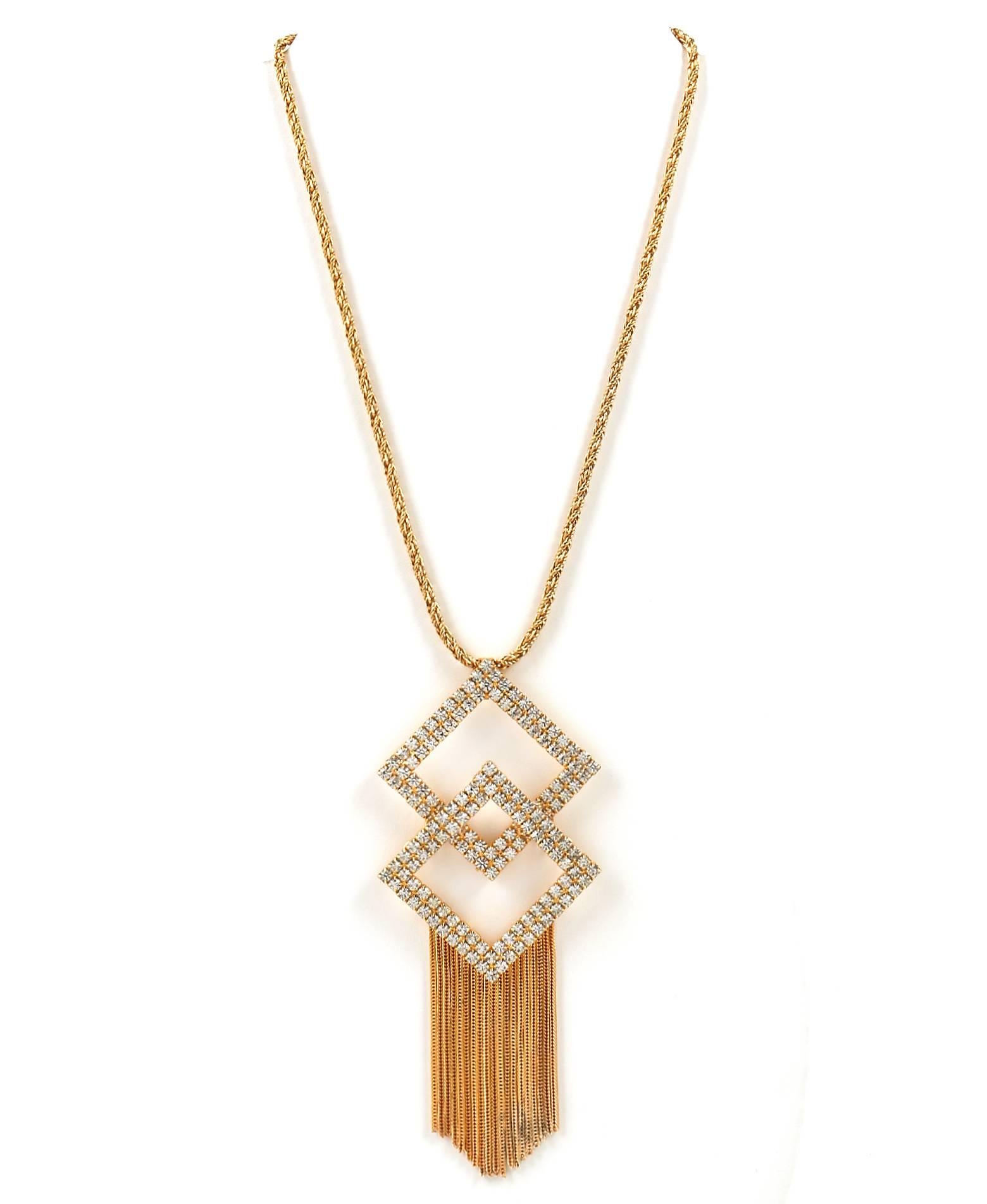 Vintage c.1960's Hobe crystal geometric statement pendant with gold-tone chain tassels and rope chain. Two large overlapped cut out diamond shaped pendants have two rows of prong set round clear crystals. Several fine gold tone chain tassels hang