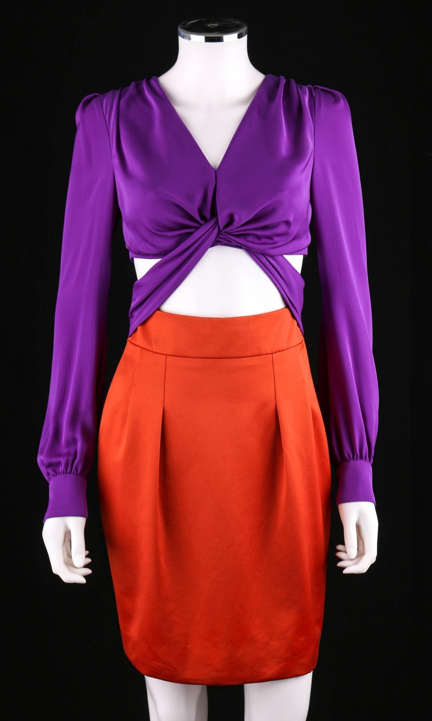 Gucci Spring/Summer 2011 orange / purple color block dress. Cut-out knotted style midriff. Long sleeves button at cuffs. V-neckline. Pleated detail at shoulders. Zips at center back. Worn by numerous celebrities including Jennifer Lawrence, January