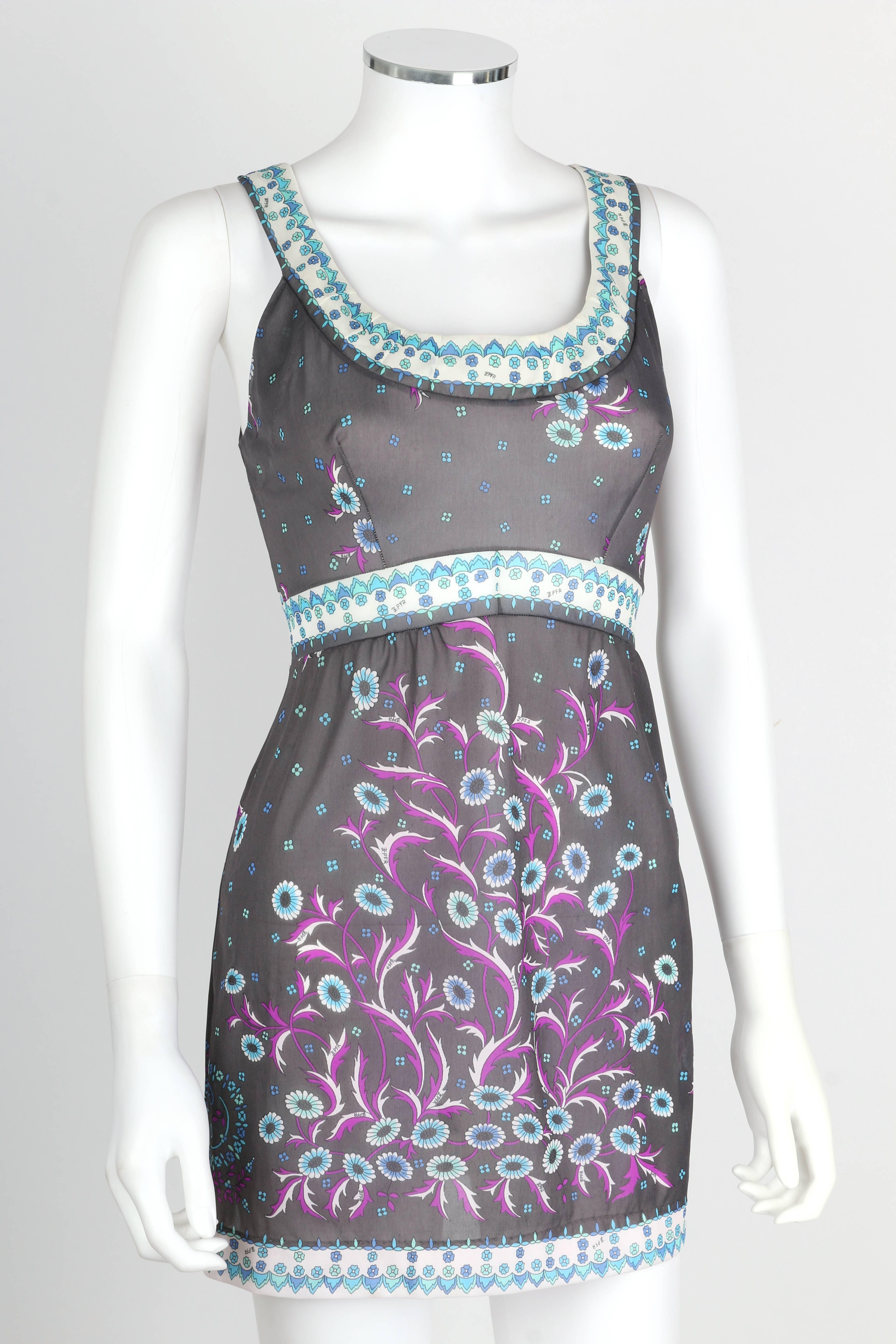 Vintage c.1960's Emilio Pucci for Formfit Rogers floral print mini dress/tunic in shades of gray, purple, blue and white. Sleeveless. Empire waistline. Rounded scoop neckline. Decorative floral border around neckline, waist, and hem. Slip-on style.