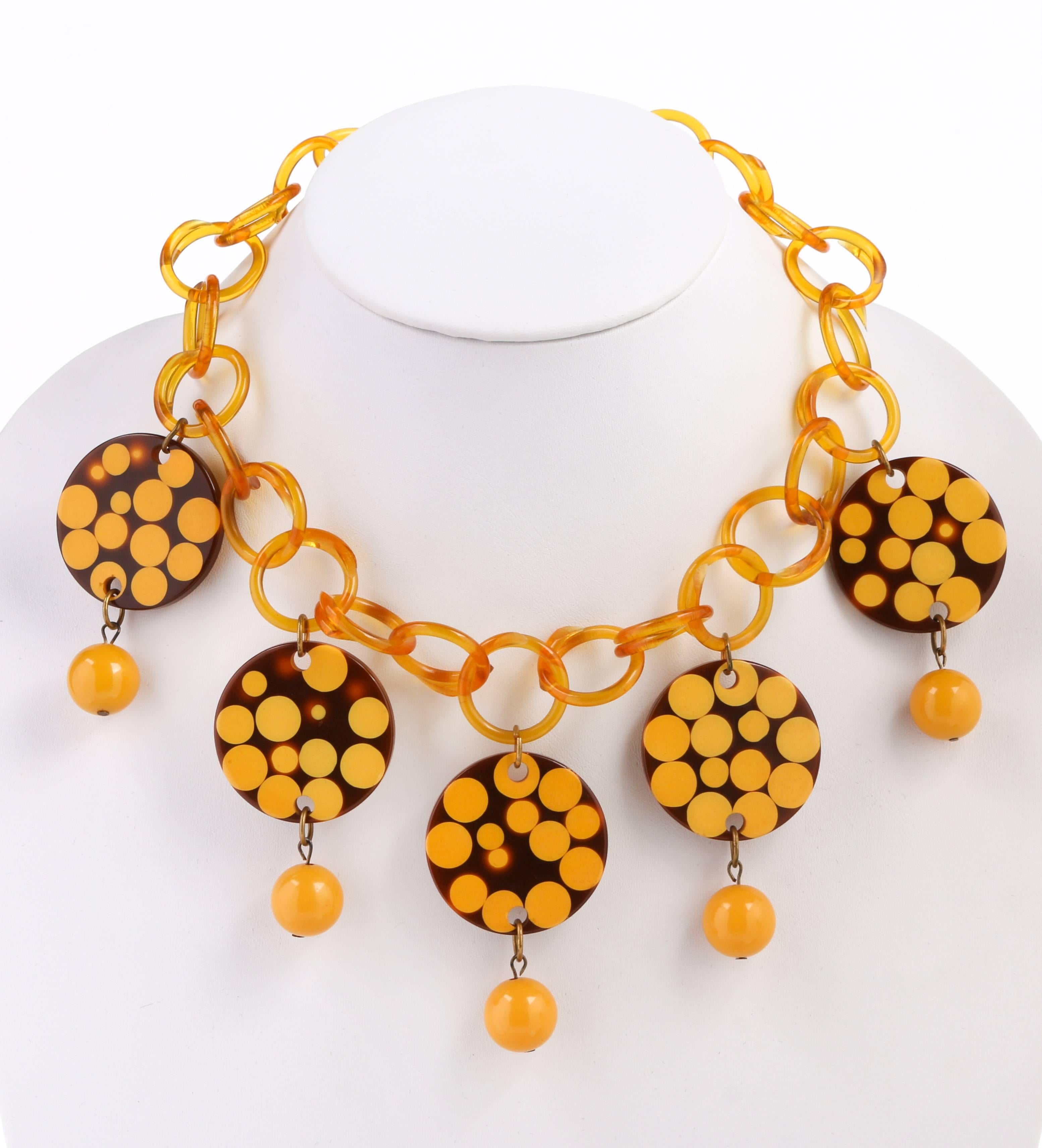 A rare, one of a kind, Charles Elkaim Bakelite link necklace. Large open link butterscotch colored round link chain (each link slightly under 1”) with a front section of five large brown discs (approximately 1.5”) with polka dot detail. Bold yellow
