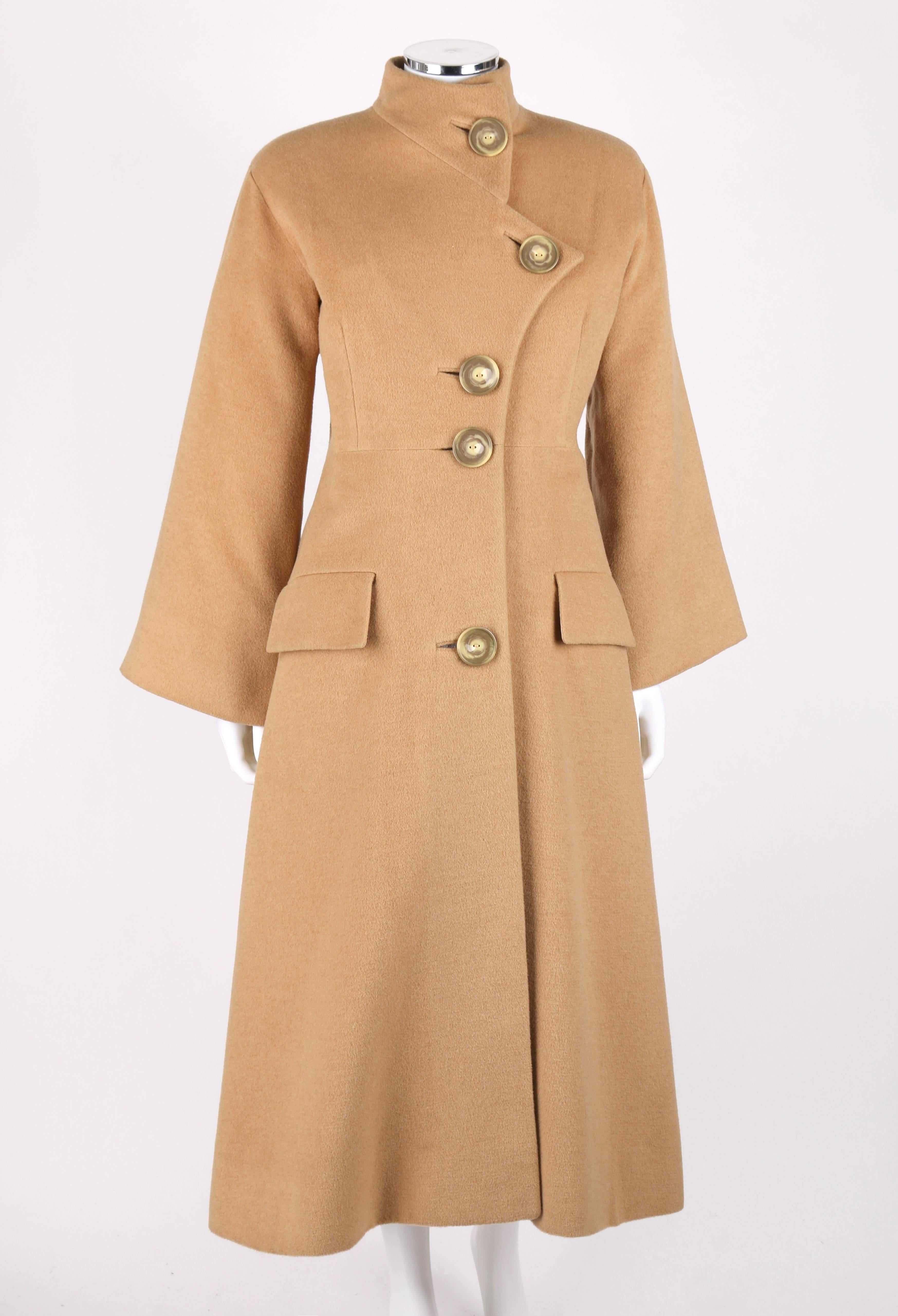 Vintage c.1980's Alik Singer camel cashmere long princess car coat. Asymmetrical notched collar large button front closure, if worn open becomes a symmetrical lapel. Two flap pockets at each hip. Long wide sleeve. Lightly padded shoulder pads. Fully