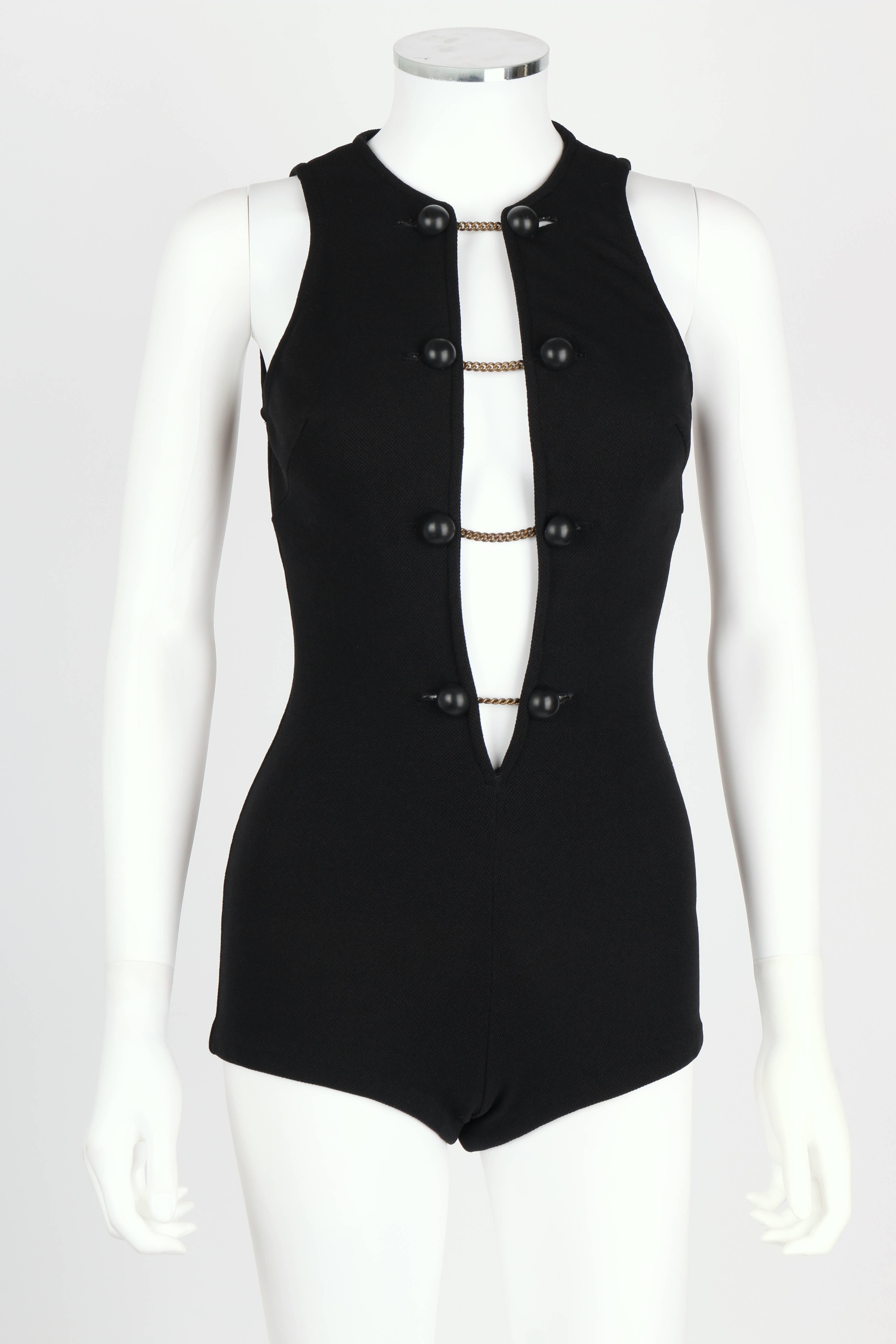 Vintage c.1960's Donald Brooks for Sinclair black pique knit bathing/play suit. Plunging neckline closes with black buttons on chains. Sleeveless. Lined pantie area. Unmarked Fabric Content: Polyester or rayon; Lining: Nylon.

Measurements: