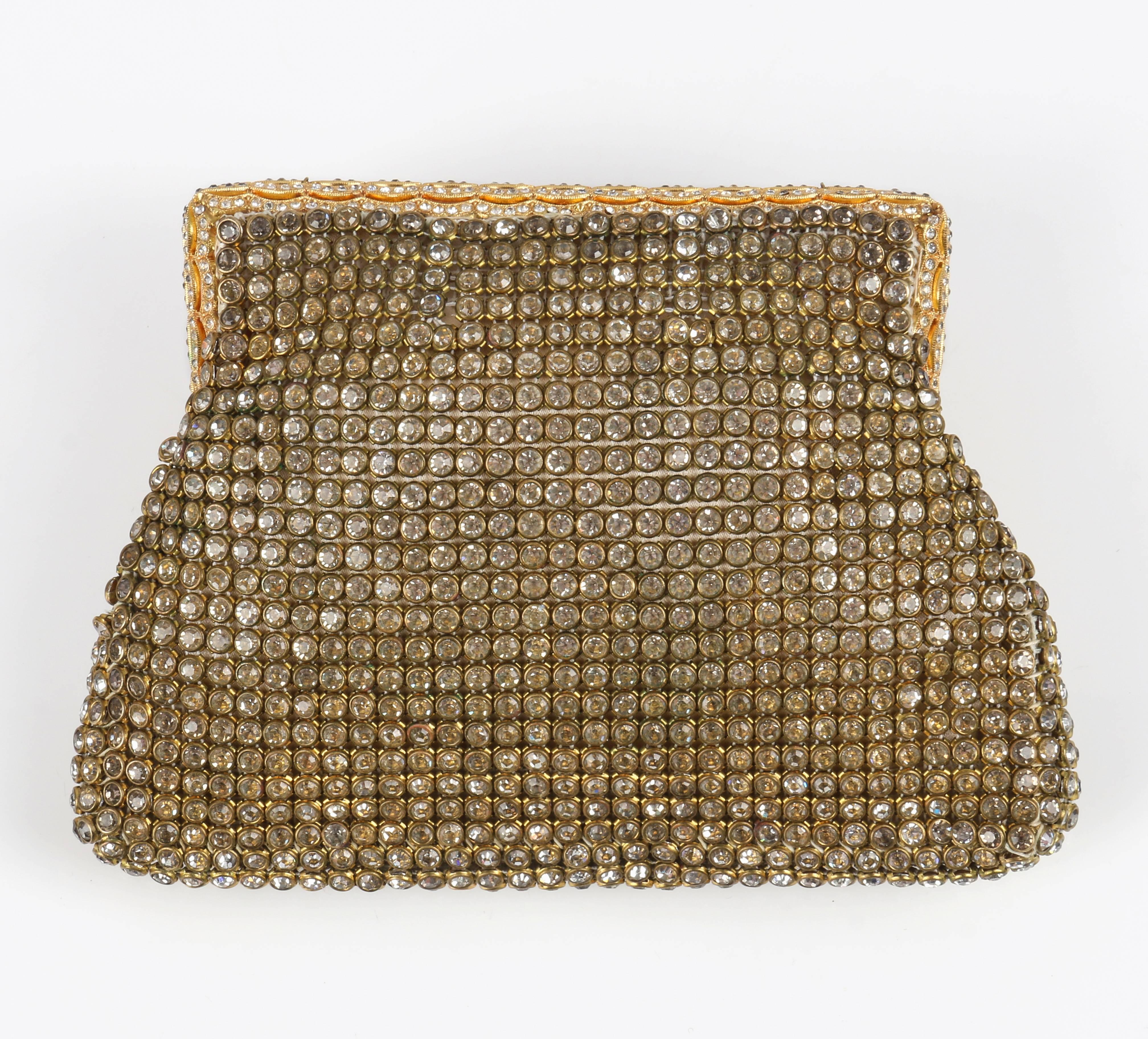Vintage c.1950's gold rhinestone mesh evening bag. Rhinestone mesh body. Rectangular frame with scalloped open work gold toned metal and rhinestone detail. Hinge clasp closure with matching scallop detail. Fully lined in cream satin silk. Unmarked.