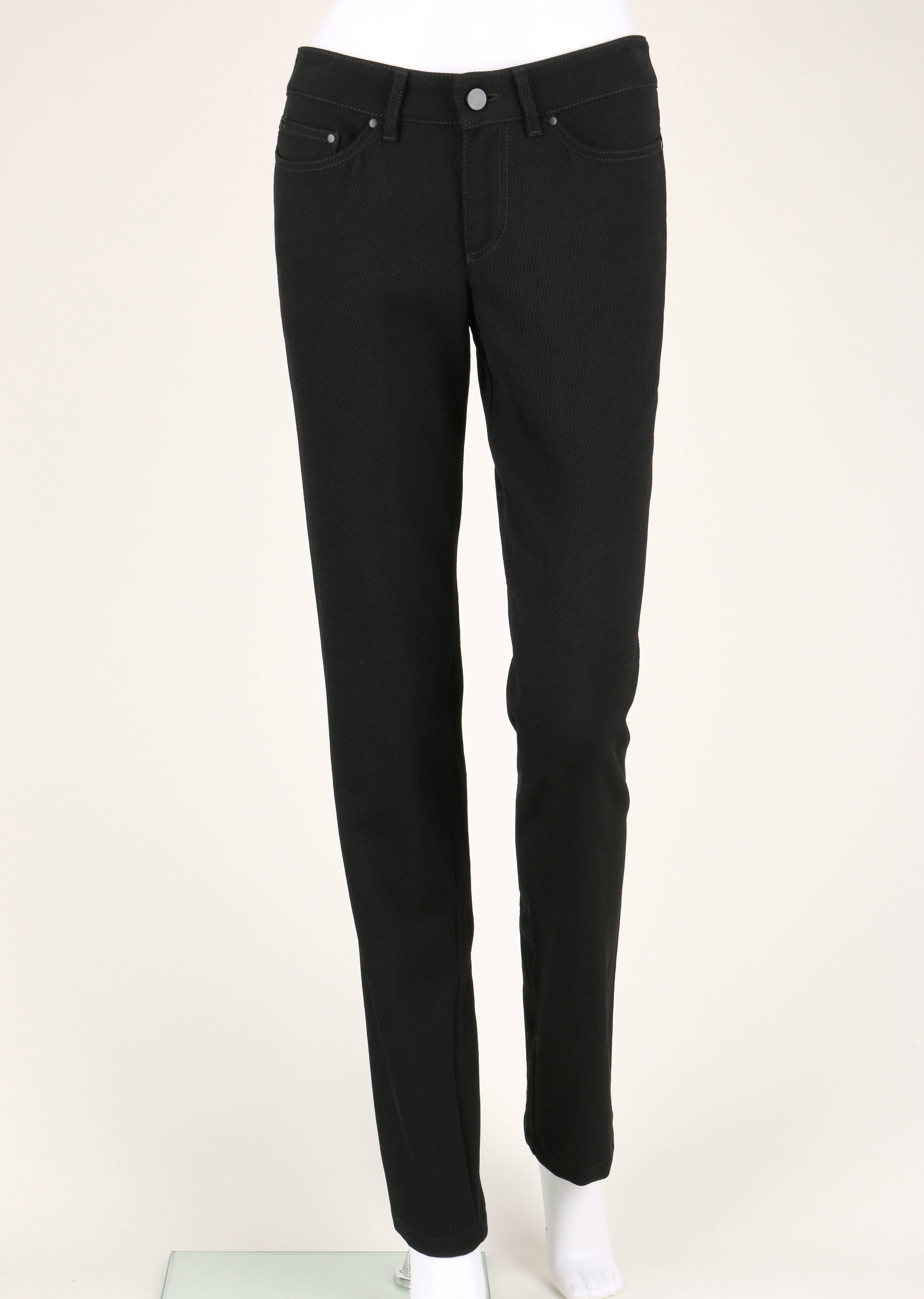 Alexander McQueen c.2007 black ribbed wool pants. Classic five pocket style. Straight leg. Embroidered skull detail on back right pocket. Patent leather trimmed zipper detail at back of legs. Belt loops. Zipper fly and button closure. Photographed