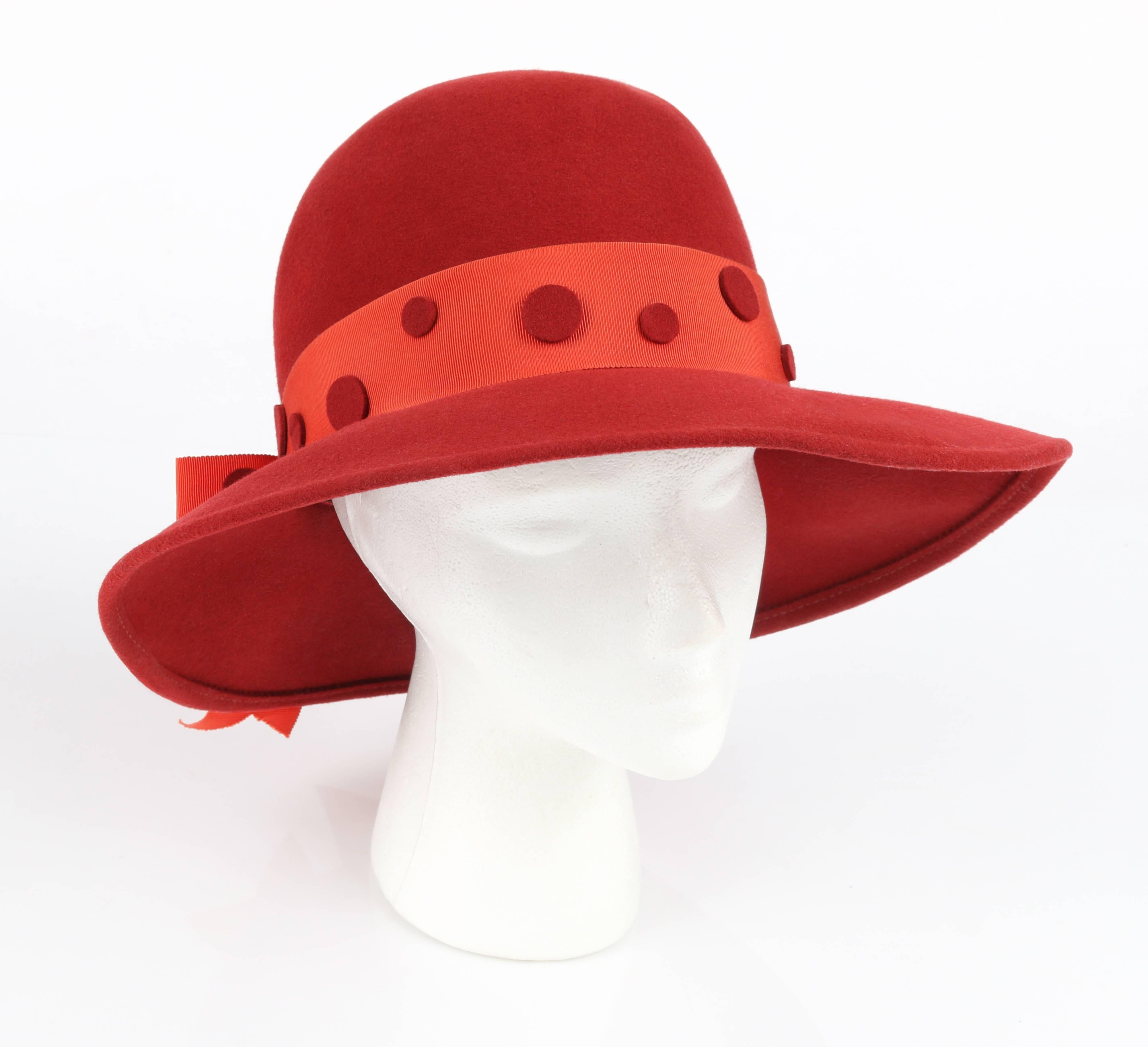Vintage Pierre Cardin c.1960's red wool felt mod fedora style hat. Wide turned down brim. Orange grosgrain ribbon hat band with large v-tailed bow at back. Various sized red wool felt polka dot detail along hat band. Unlined. Red grosgrain ribbon