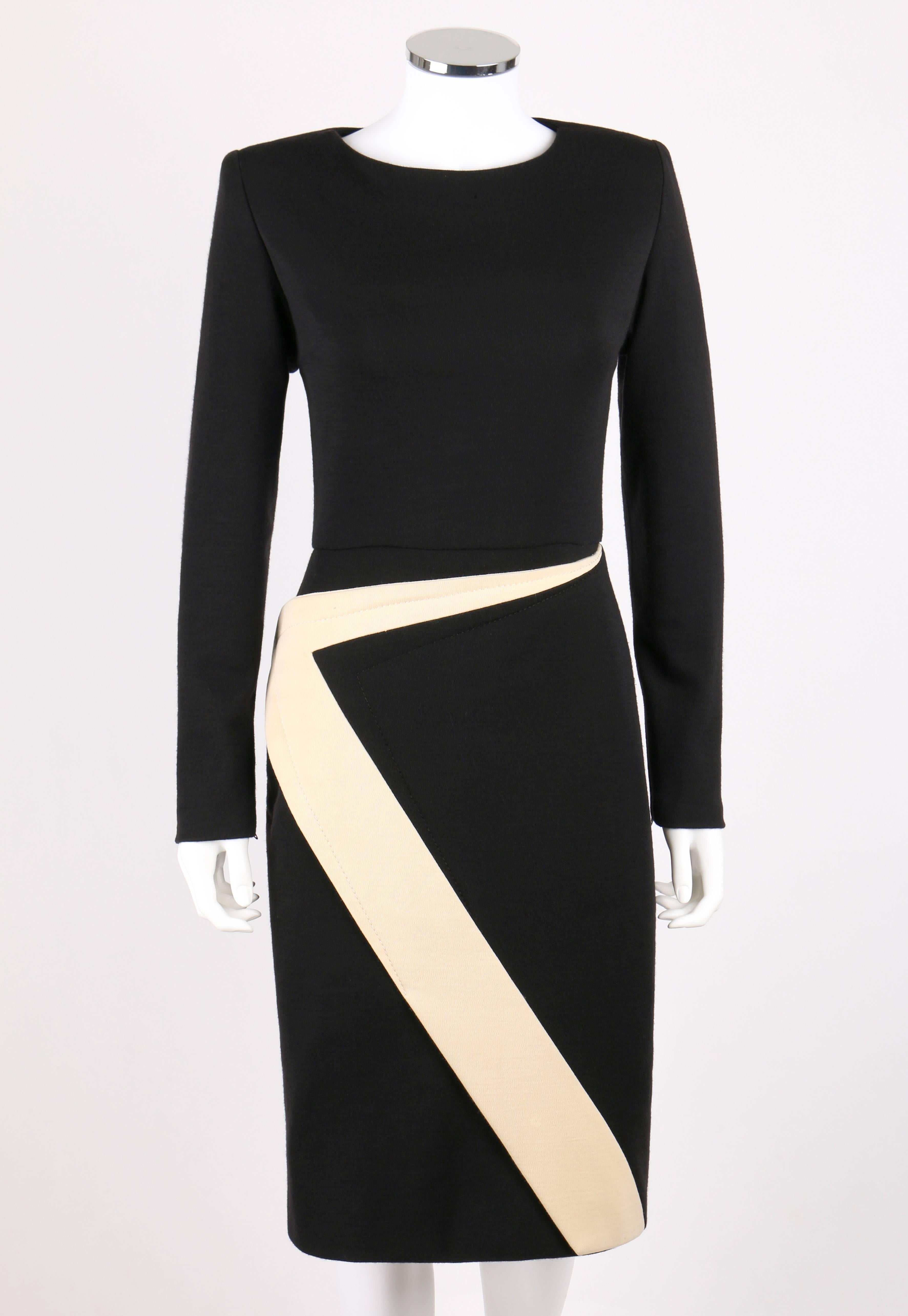 Vintage Galanos c.1980's wool knit shift dress. Black crew neckline dress. Long sleeves with zipper closures at cuffs. Ivory geometric avant garde zig zag detail from waistline to hem forming front wrap panel. Center back zipper closure with hook