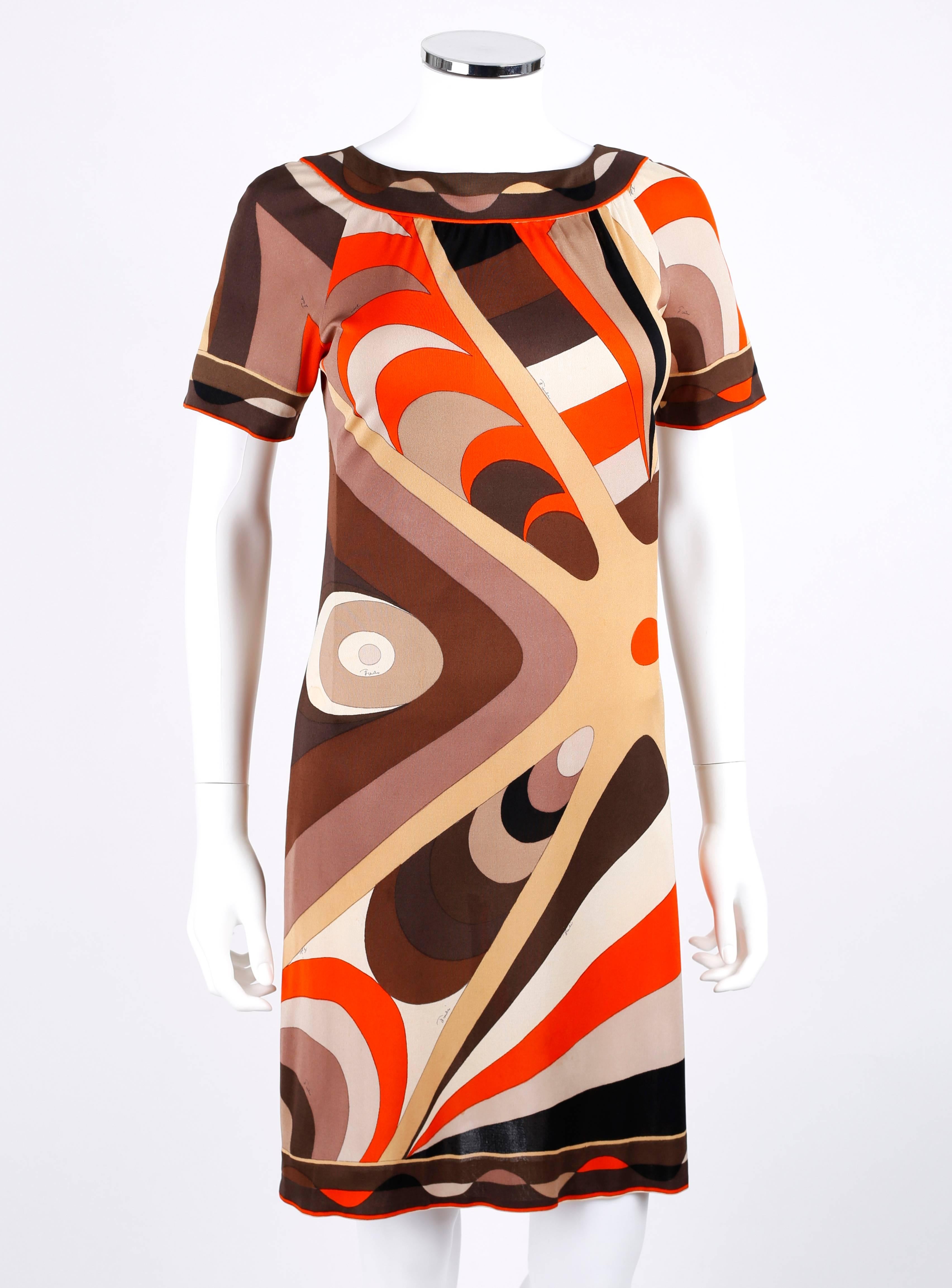 Vintage c.1960's Emilio Pucci for Neiman Marcus silk jersey shift dress. Abstract op art signature print in shades of brown, orange, gray, and black. Short raglan sleeves. Boat neckline. Off center invisible zipper with hook and eye closure at back.