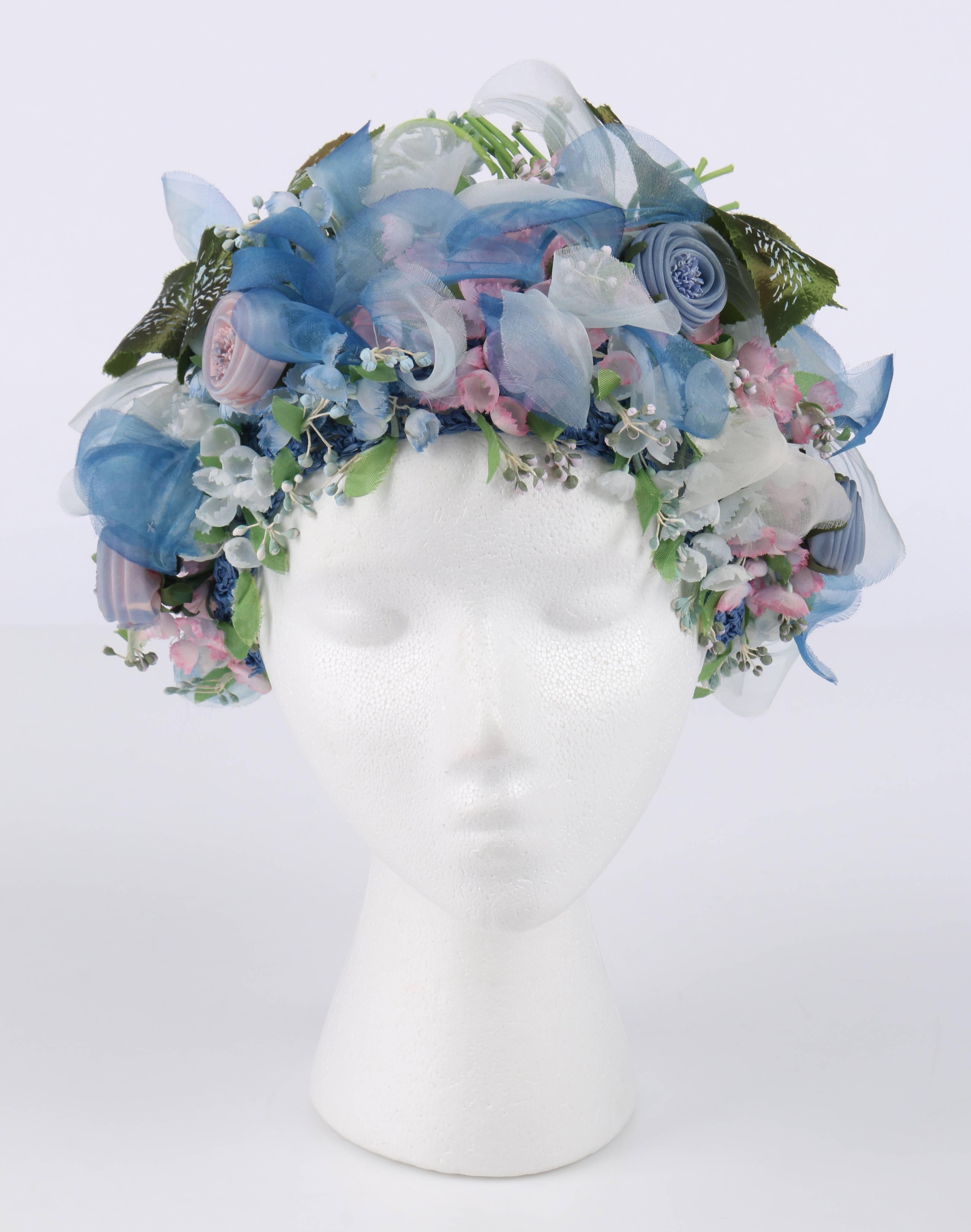 Vintage Miss Dior created by Christian Dior c.1960's silk floral capulet style hat. Blue, white, pink, and green silk flowers and leaves. Blue straw crochet mesh base with silk crochet top. Unlined. Unmarked Fabric Content: Silk and straw.