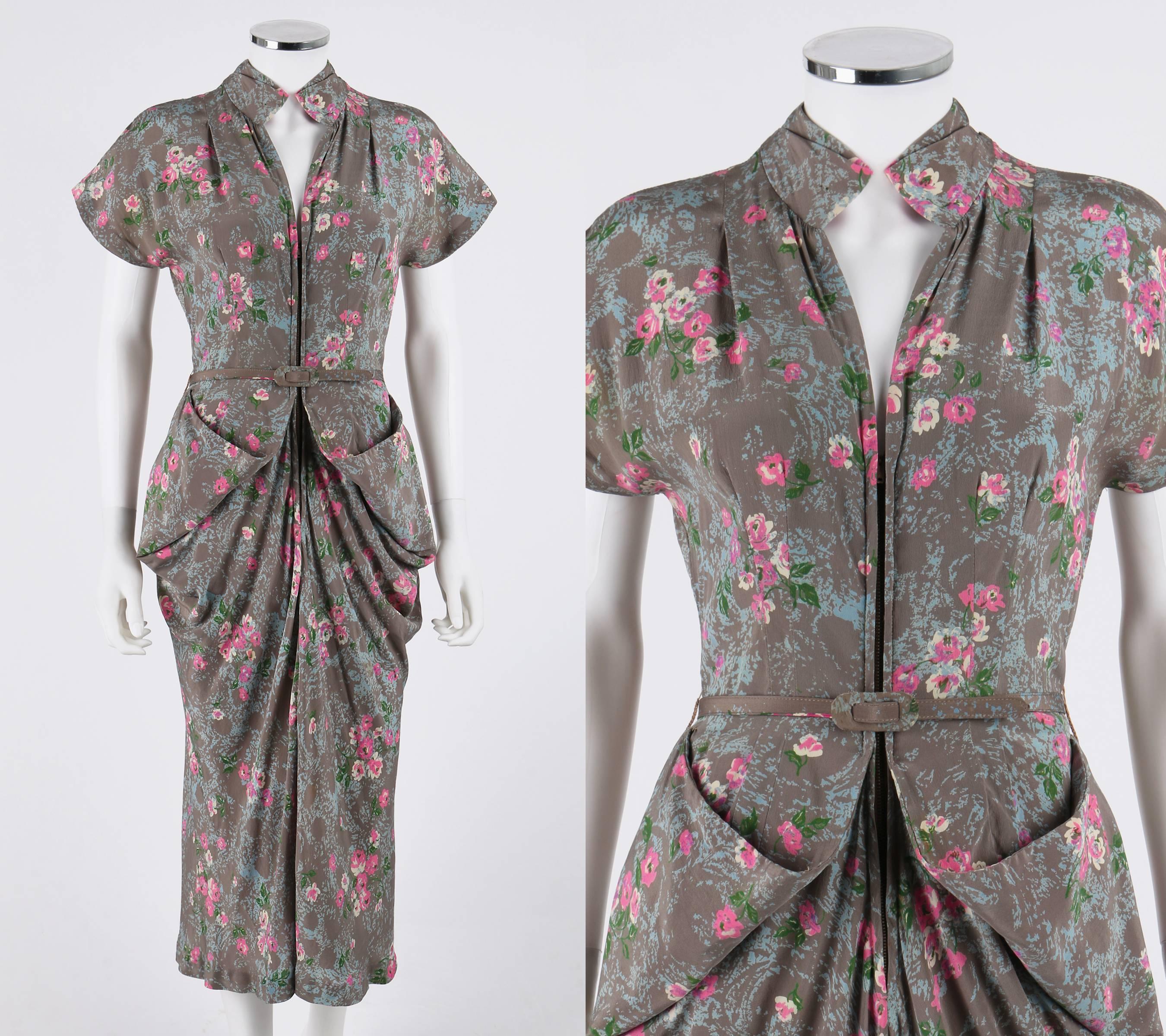Vintage Couture c.1940's gray floral print silk day dress. Gray, light blue, pink, white, and green floral print silk. Extended shoulders. V-neckline. Stylized mandarin collar. Front shoulder pleats. Center front metal zipper closure. Bust line