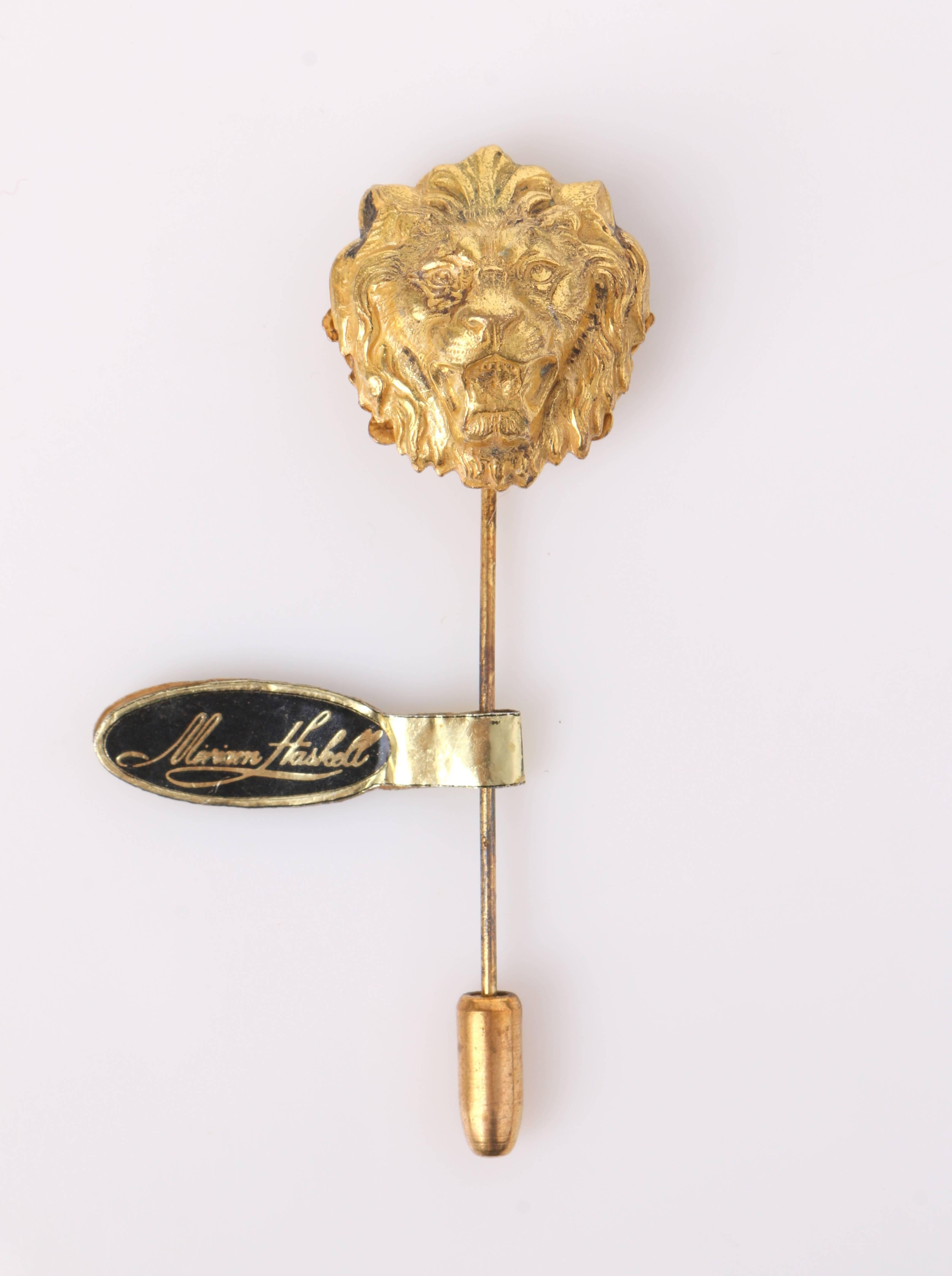 New Old Stock - Vintage Miriam Haskell c.1950's gold 3-D lion head hat / stick pin. Designed by Frank Hess. Gold-toned molded metal intricate lion head with floral filigree backing. Long stick pin is attached at center back with gold-toned end cap.