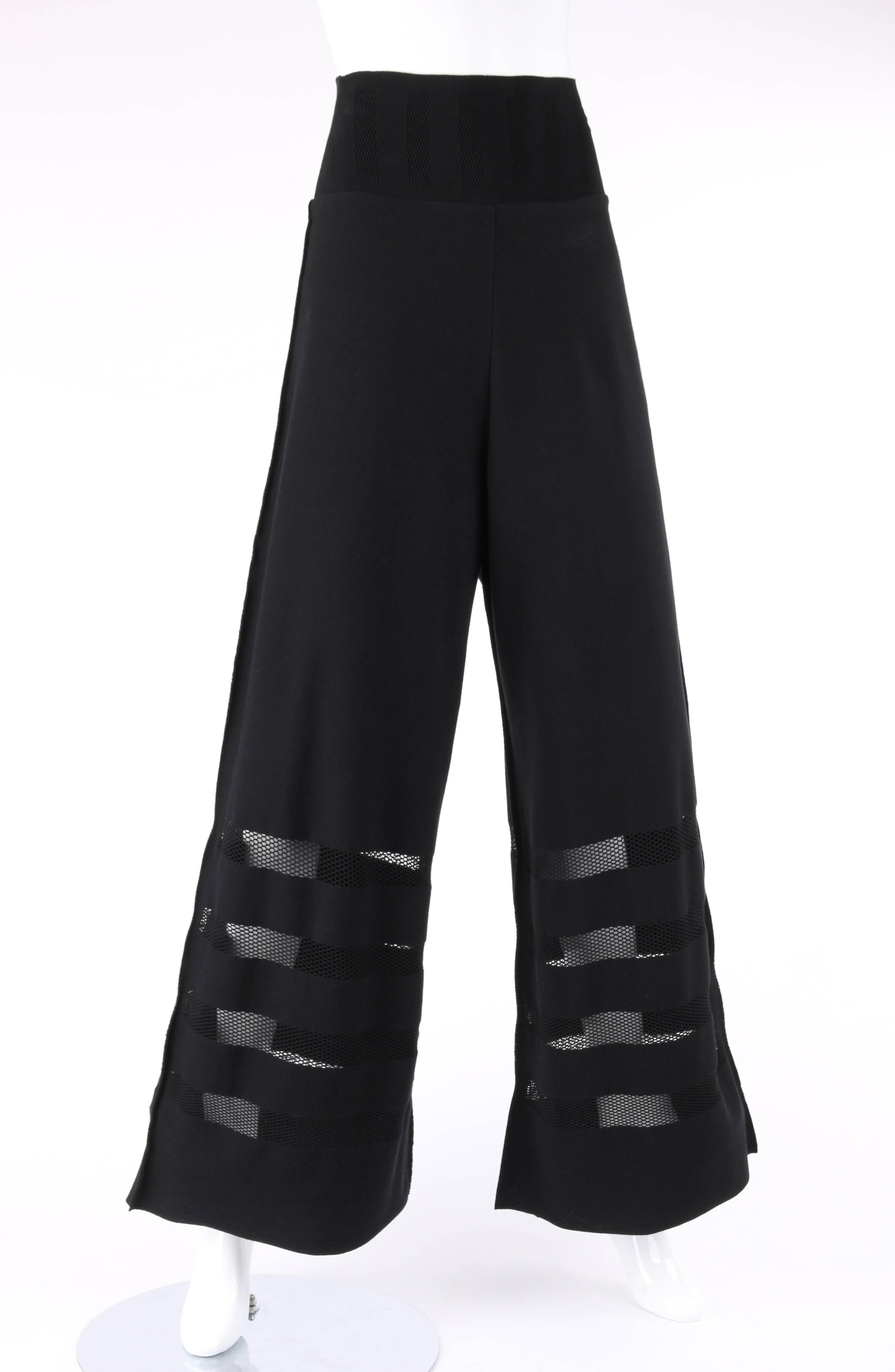 Issey Miyake A-Poc Inside black knit mesh detail wide leg pants. Designed by Dai Fujiwara. Wide yoke waistline with mesh inset detail. High waisted. Wide leg style. Four horizontal mesh panels along bottom. Raw edge detail at waistline and hem.