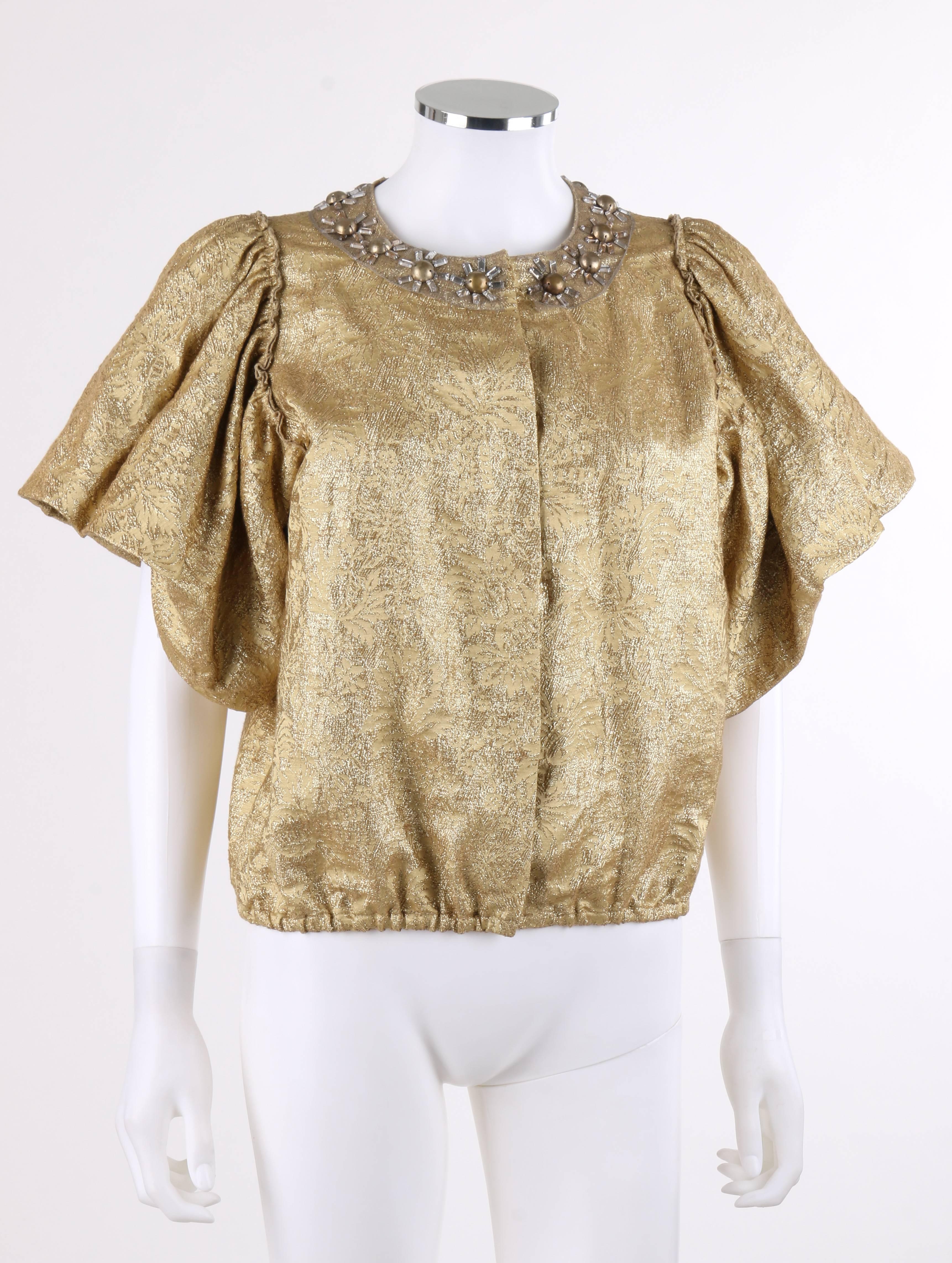 Lanvin Spring/Summer 2007 metallic gold silk floral brocade jacket designed by Alber Elbaz. Short flounced sleeves with bubble hem. Crew neckline. Clear rectangular rhinestone and gold-toned domed bead embellishment in floral/sunburst shape over