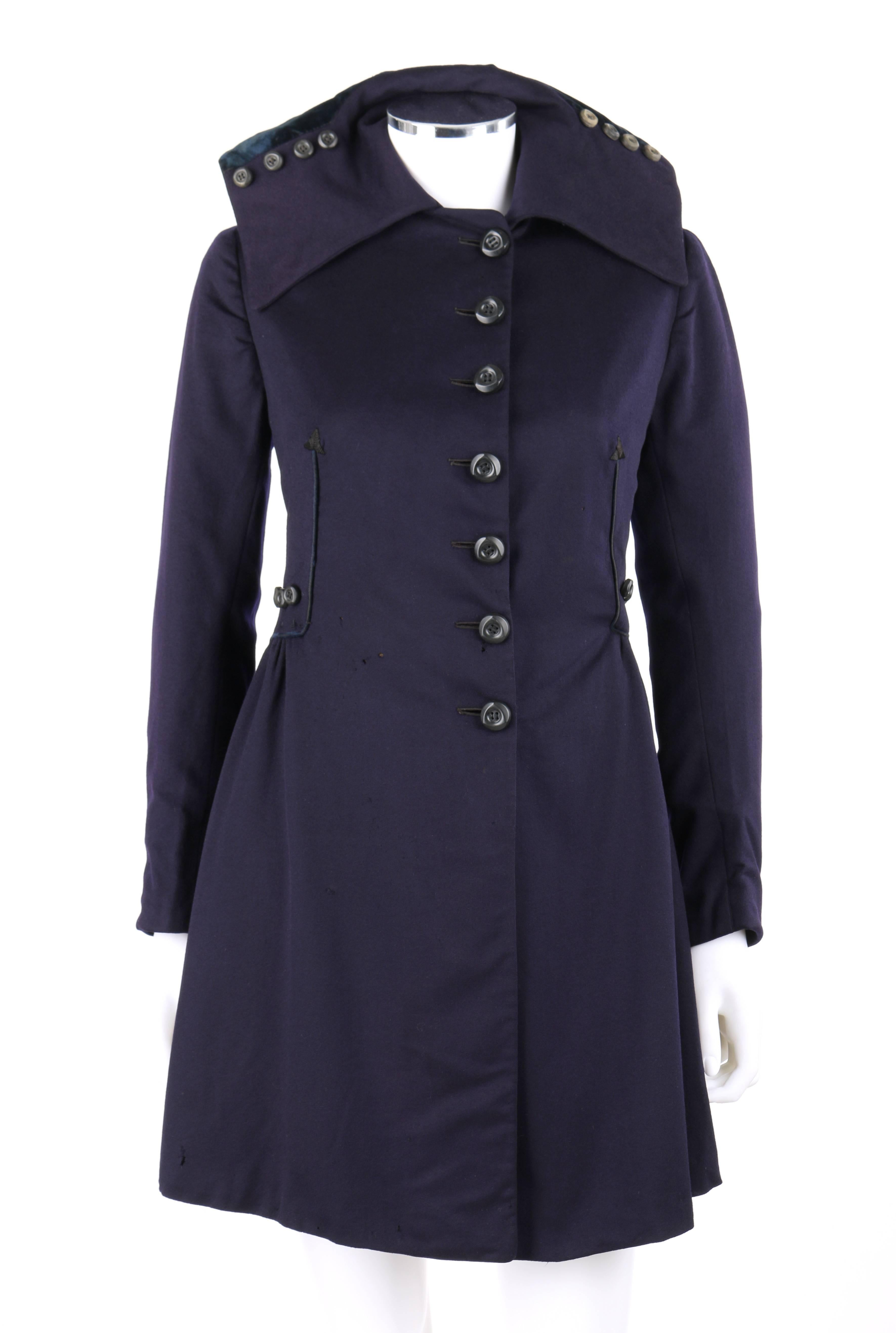 Vintage Edwardian couture c.1910's navy blue wool military-cut walking coat. Wide flat collar with four button detail on either side and flounced dark teal blue silk velvet at back. Seven side front button closures from neckline to hips. Long
