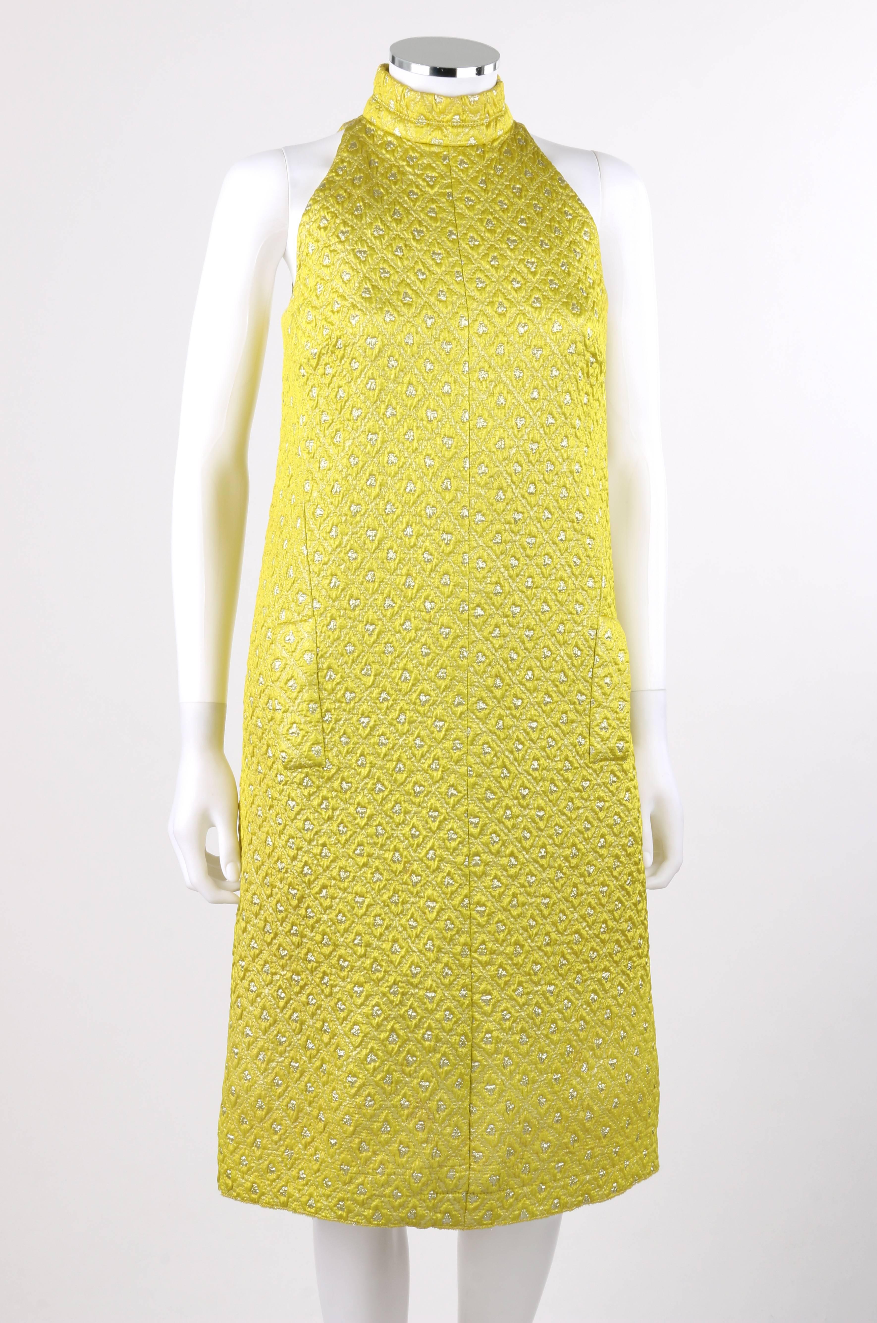 Vintage Jean Patou late 1960's yellow and silver diamond brocade halter cocktail dress. Yellow and silver lurex diamond patterned brocade. Mandarin collar. Halter cut bodice. Sleeveless shift style. Center back zipper closure with two hook and eye