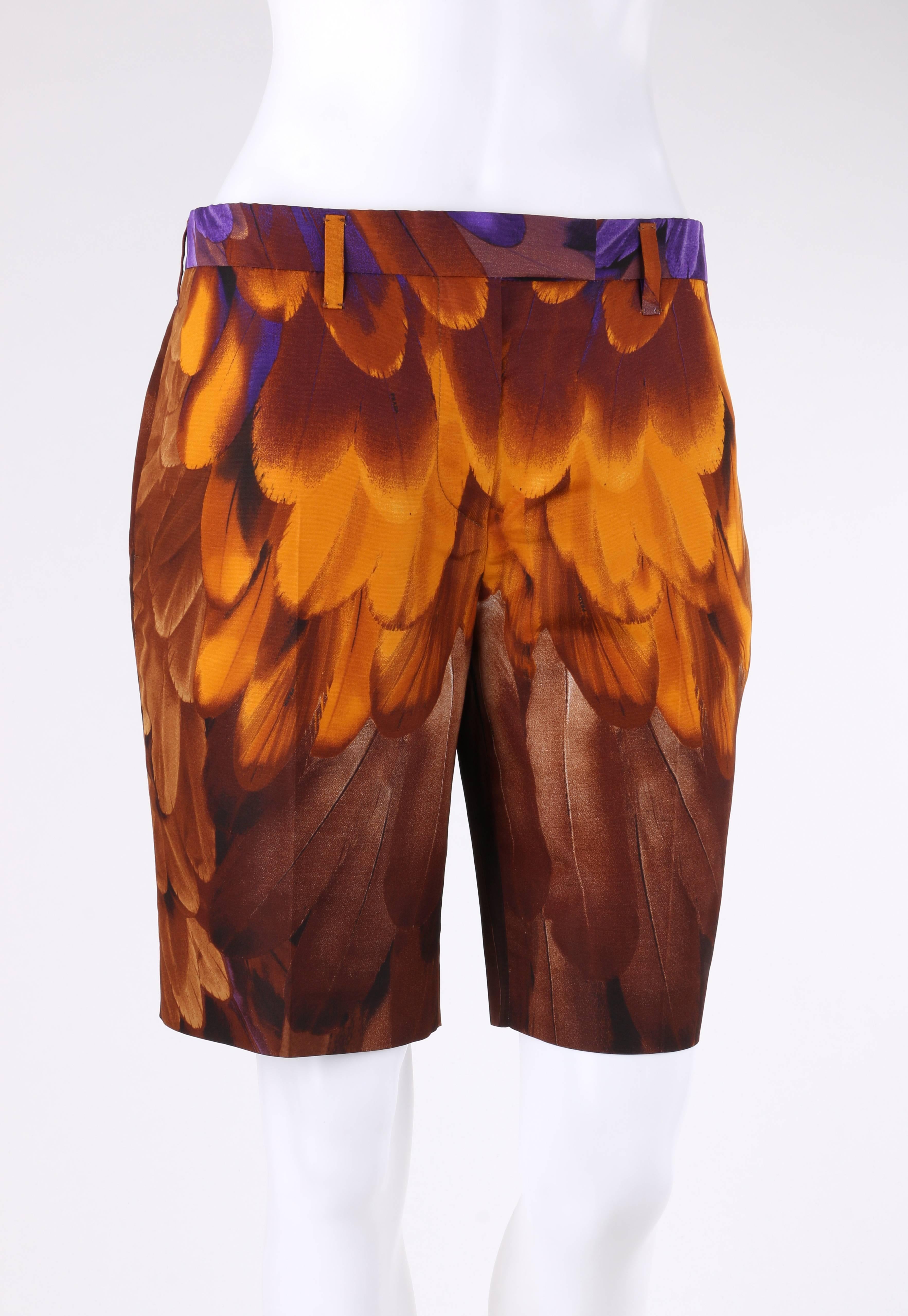 Prada Spring/Summer 2005 brown and gold feather print silk Bermuda shorts designed by Miuccia Prada. Leather feather signature print in shades of brown, gold, and purple. Thin banded waist with six belt loops. Center front zip fly with single