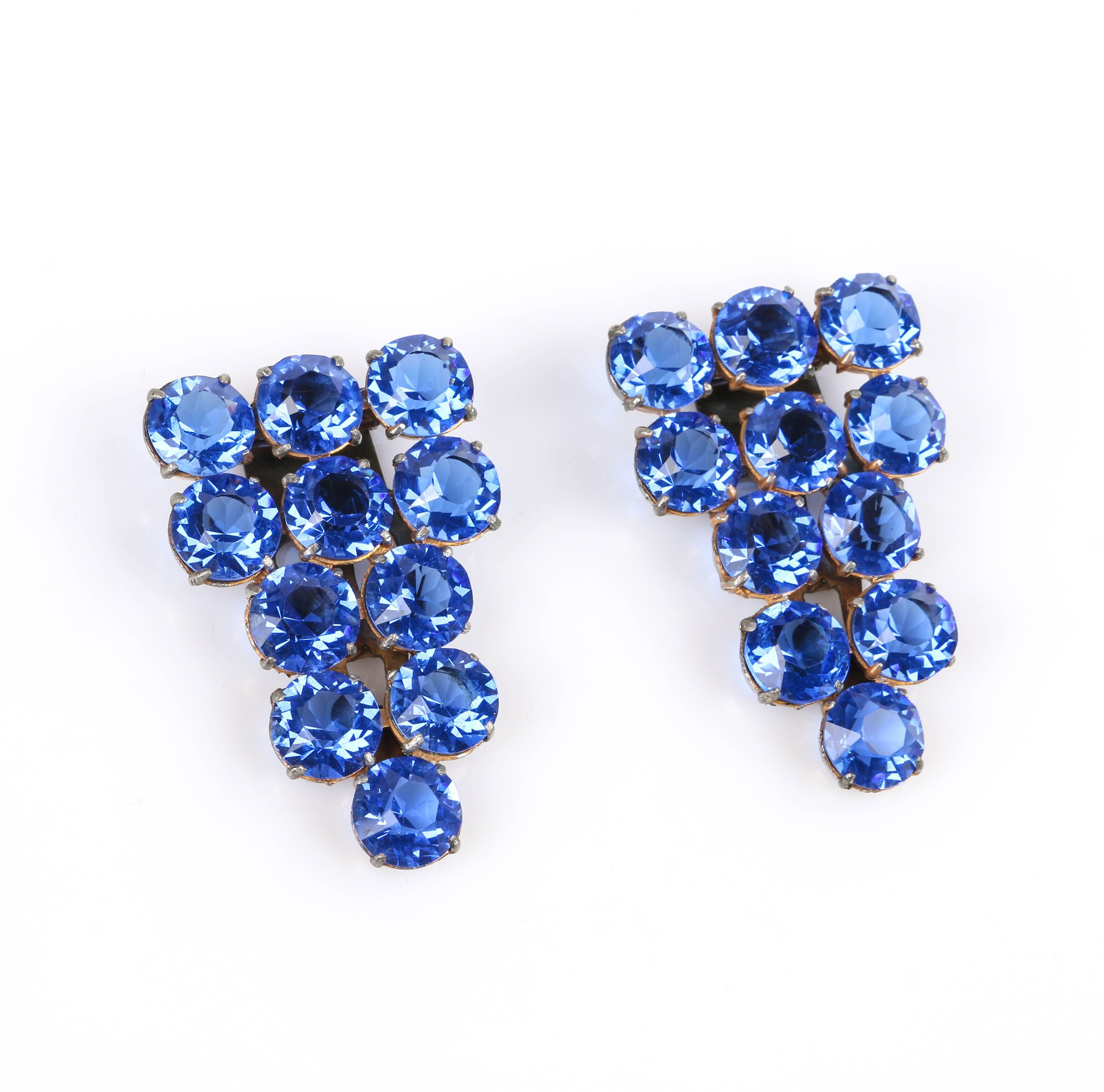 Striking vintage c.1930's two piece sapphire blue crystal rhinestone dress / fur clips set. Eleven prong set round faceted sapphire blue crystal rhinestones. Gold-toned metal open work setting. Hinged brass-toned metal pronged clasp with ornate