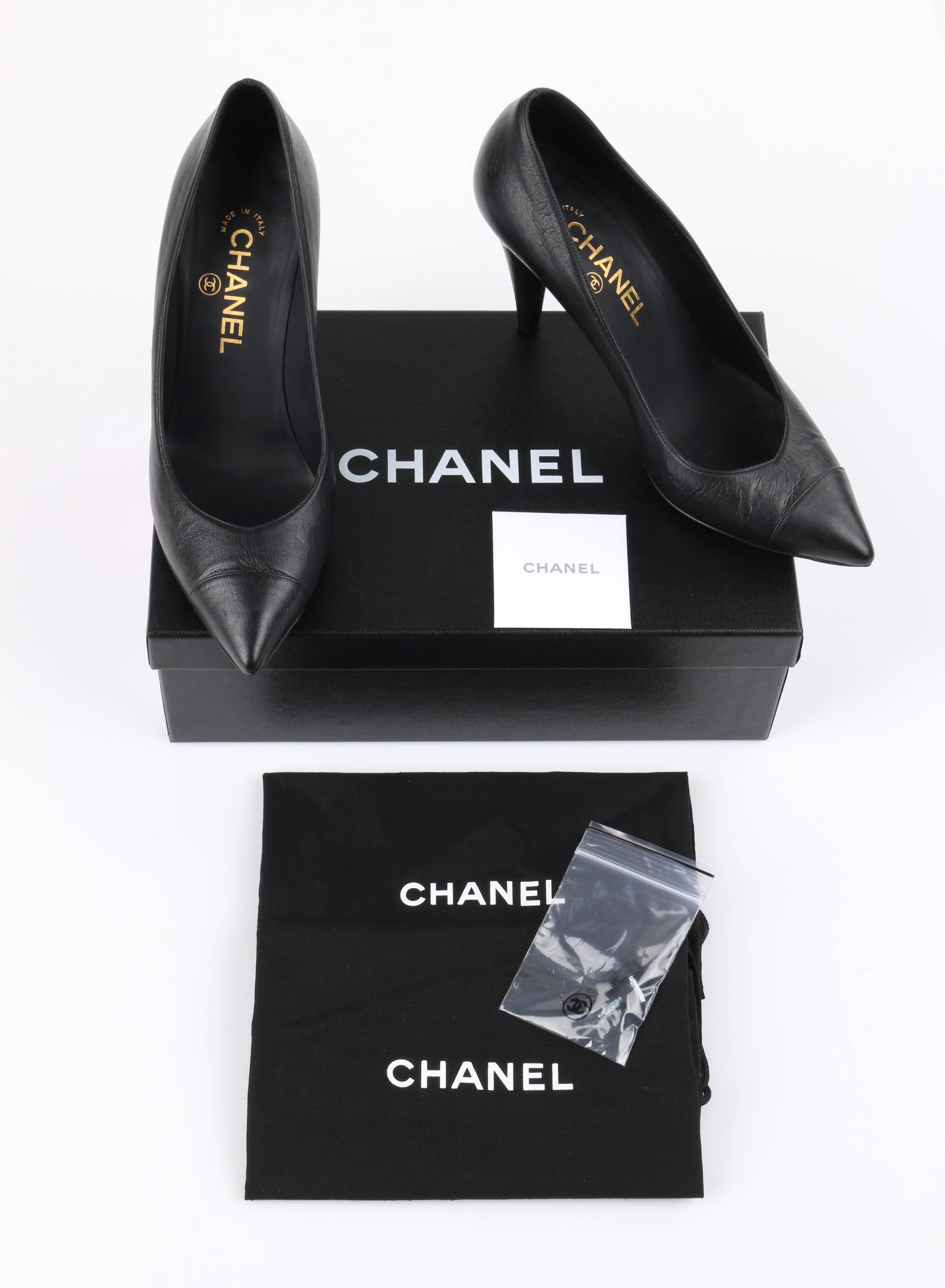 Chanel Cruise 2015 black leather pearl embellished pointed toe pumps. Designed by Karl Lagerfeld. Black textured leather upper. Pointed cap toe. Leather covered cone heel with pearl embellishment around top. Silver-toned metal 