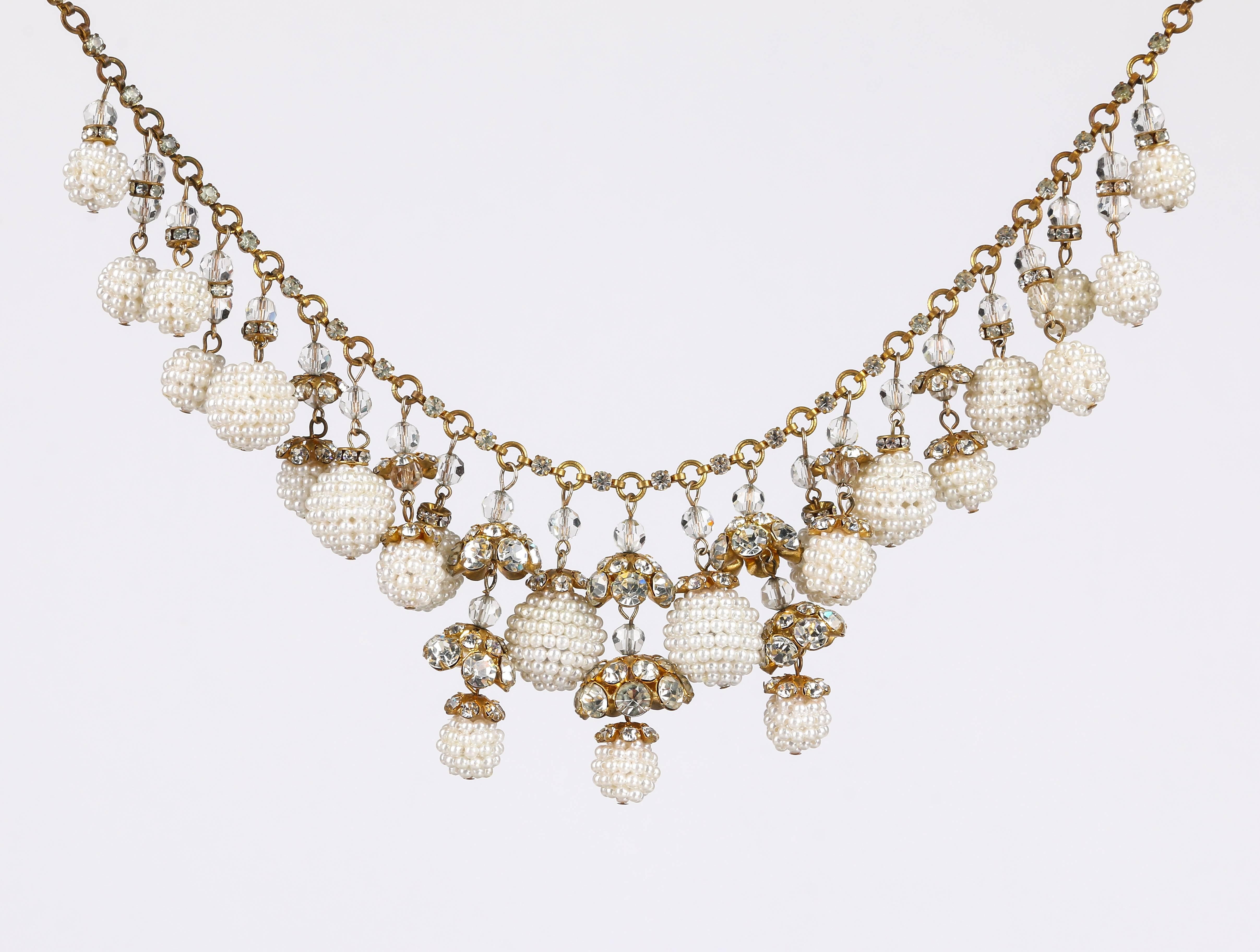 Vintage c.1950's unsigned crystal rhinestone and faux pearl cluster multi-drop bib necklace. Twenty three faux pearl seed bead cluster drops in varying sizes (12 - 18 mm) and lengths. Each drop has varied types of clear glass faceted spherical bead