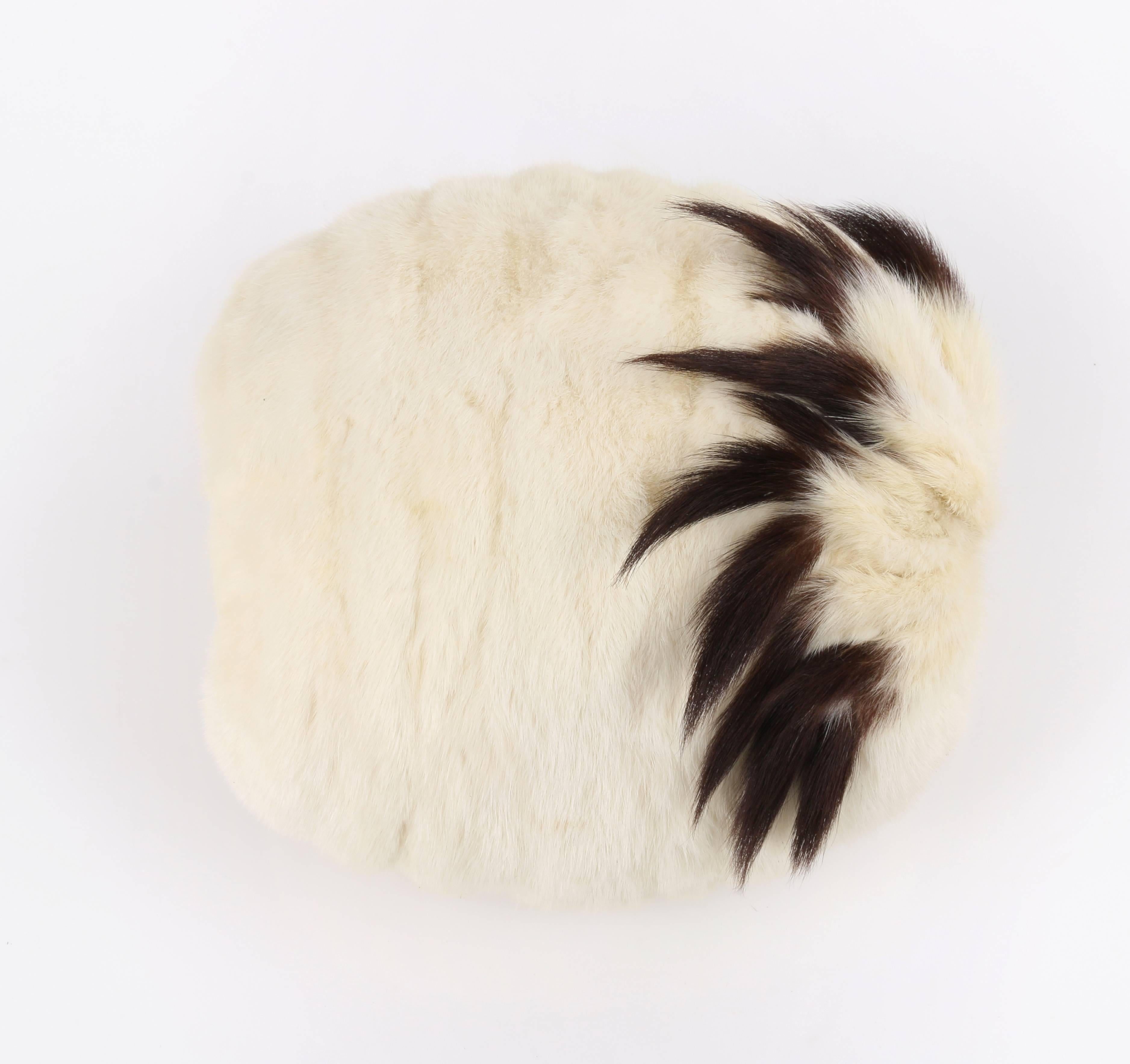 Vintage Edwardian early 1900's winter white genuine fur and tail hand warmer / muff. Winter white fur exterior with brown tipped tail detail around opening. Fully lined in beige silk satin. Singe interior fabric wrist strap. Unmarked Fabric Content: