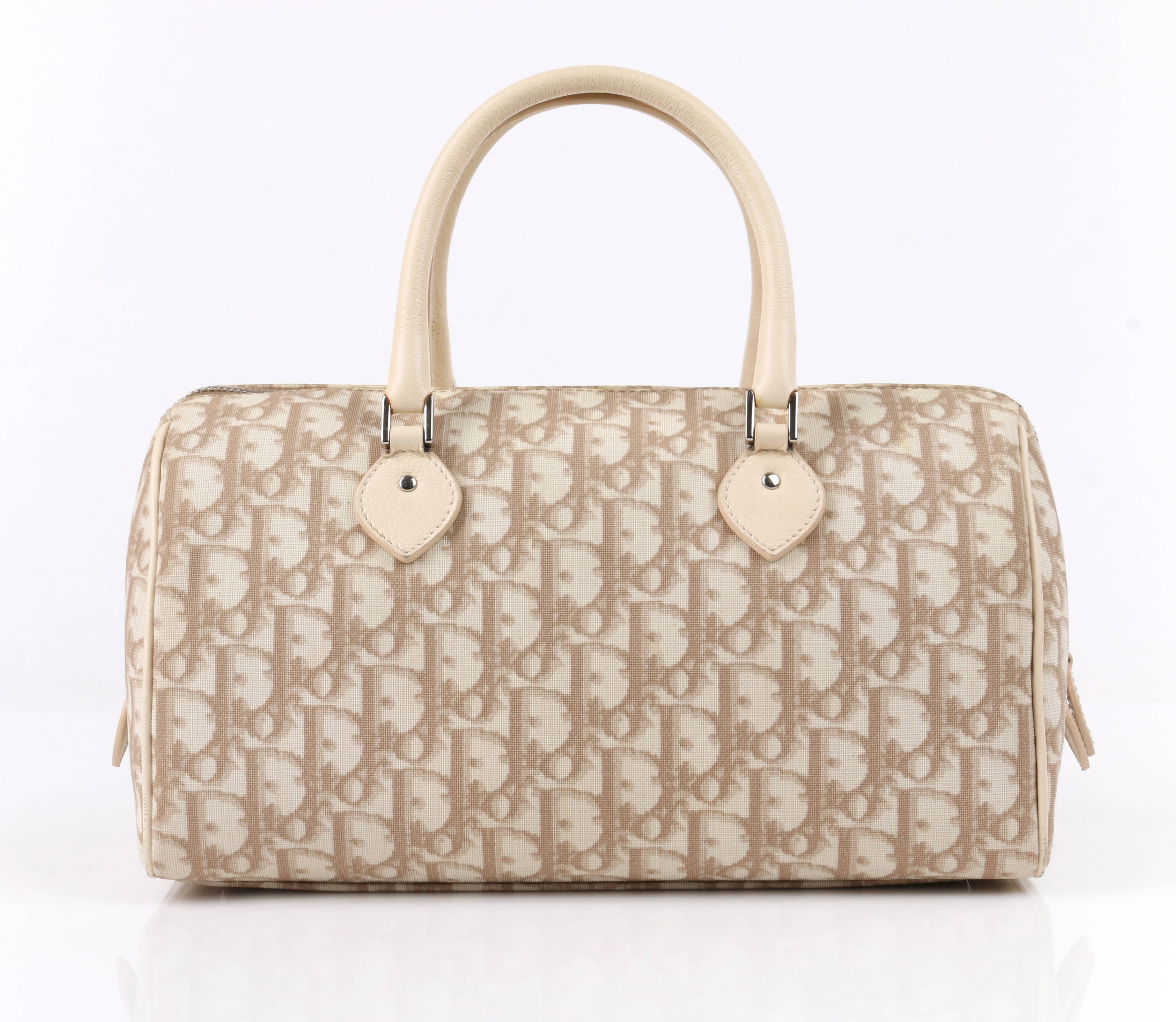 Christian Dior Spring/Summer 2005 beige Diorissimo canvas floral embroidered small boston bag. Designed by John Galliano. Signature Diorissimo monogram canvas in shades of beige with leather piping detail. Two single rolled beige leather handles.
