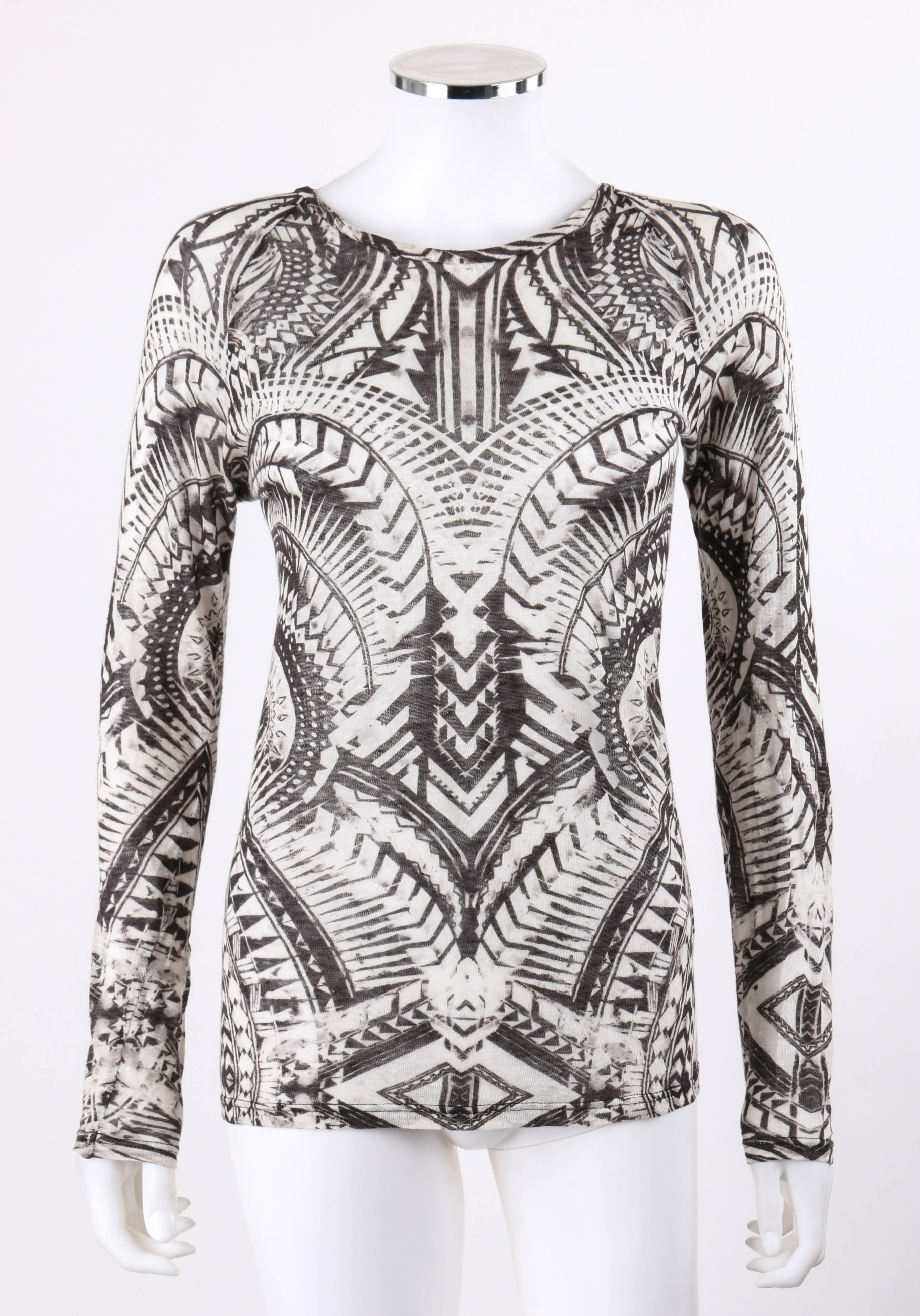 Balmain Resort 2012 black and white abstract print linen knit scoop neck top. Designed by Olivier Rousteing. Faded black and white abstract mirrored print knit. Scoop neck. Long raglan sleeves. Pull over style. Marked Fabric Content: 