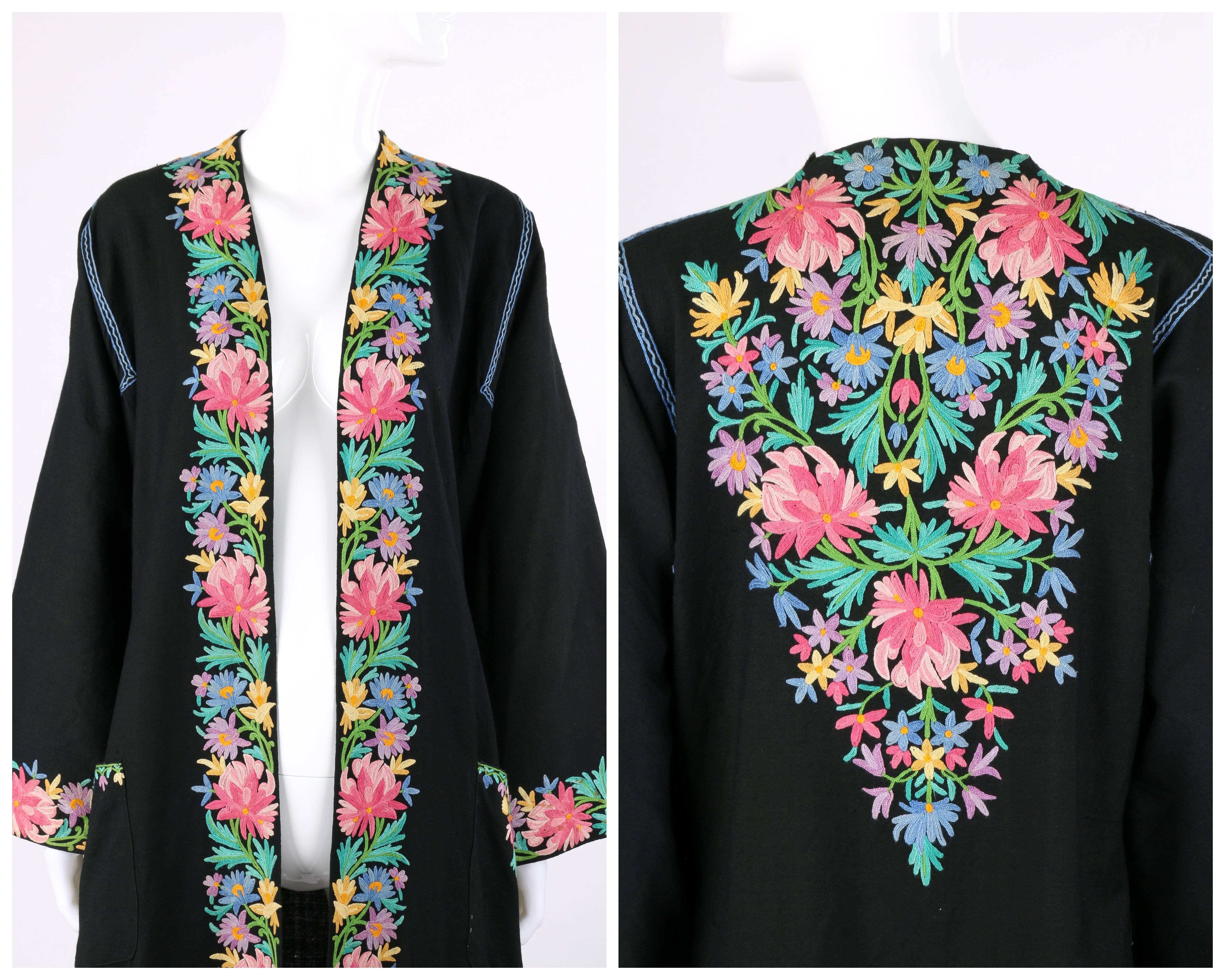 Vintage Subhana 'The Best' Srinagar black wool multi-colored floral Kashmiri embroidered robe / coat. Multi-colored crewel embroidery in a floral Kashmiri design along neckline, center front, cuffs, hem, shoulders, top of back and pockets in shades