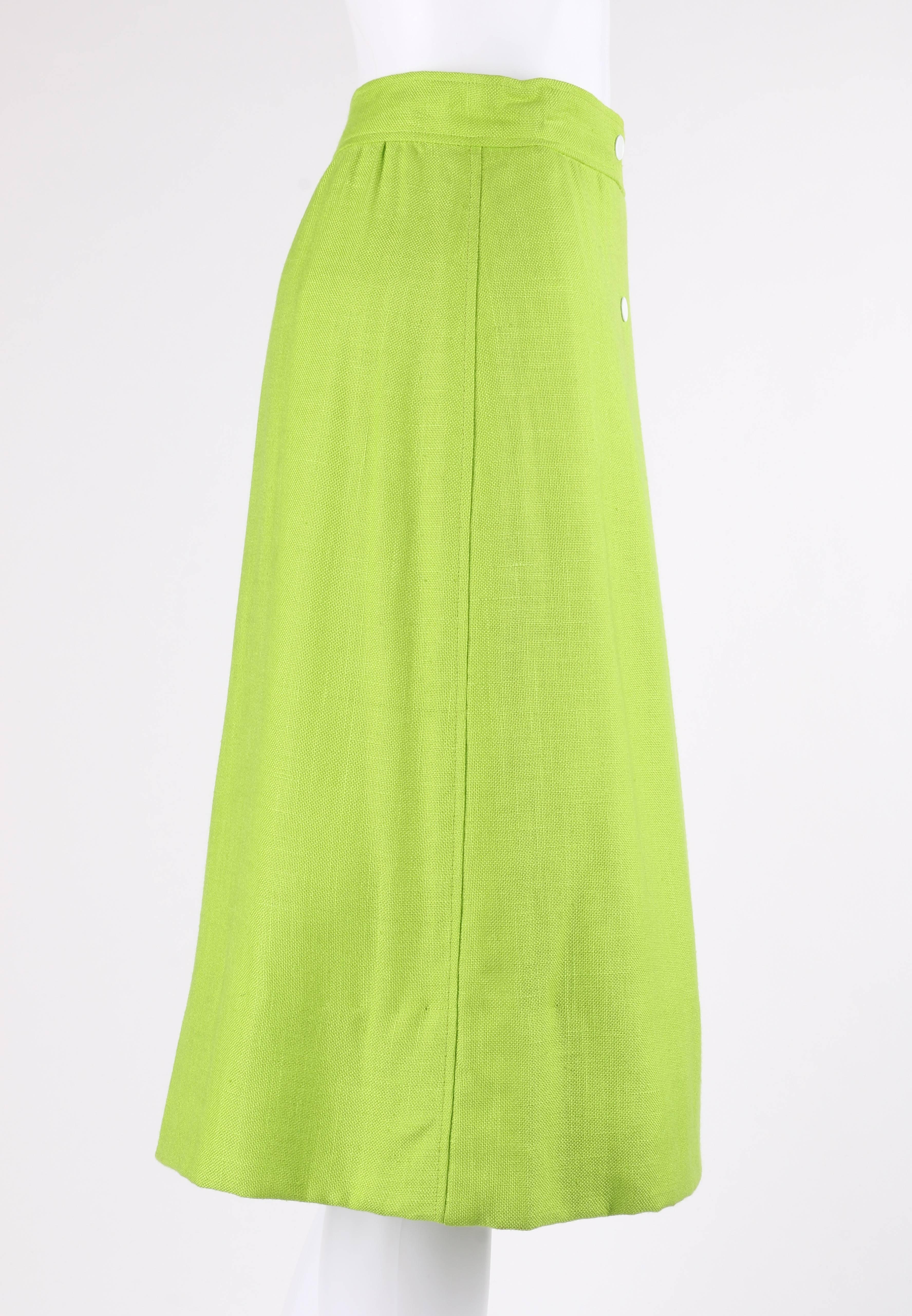 Courreges Hyperbole c.1970's Chartreuse / lime green snap front wrap skirt. Designed by Andre Courreges. Chartreuse / lime green linen-look rayon. Banded waist. Four front double row white snap closures. Single interior hook and bar closure at