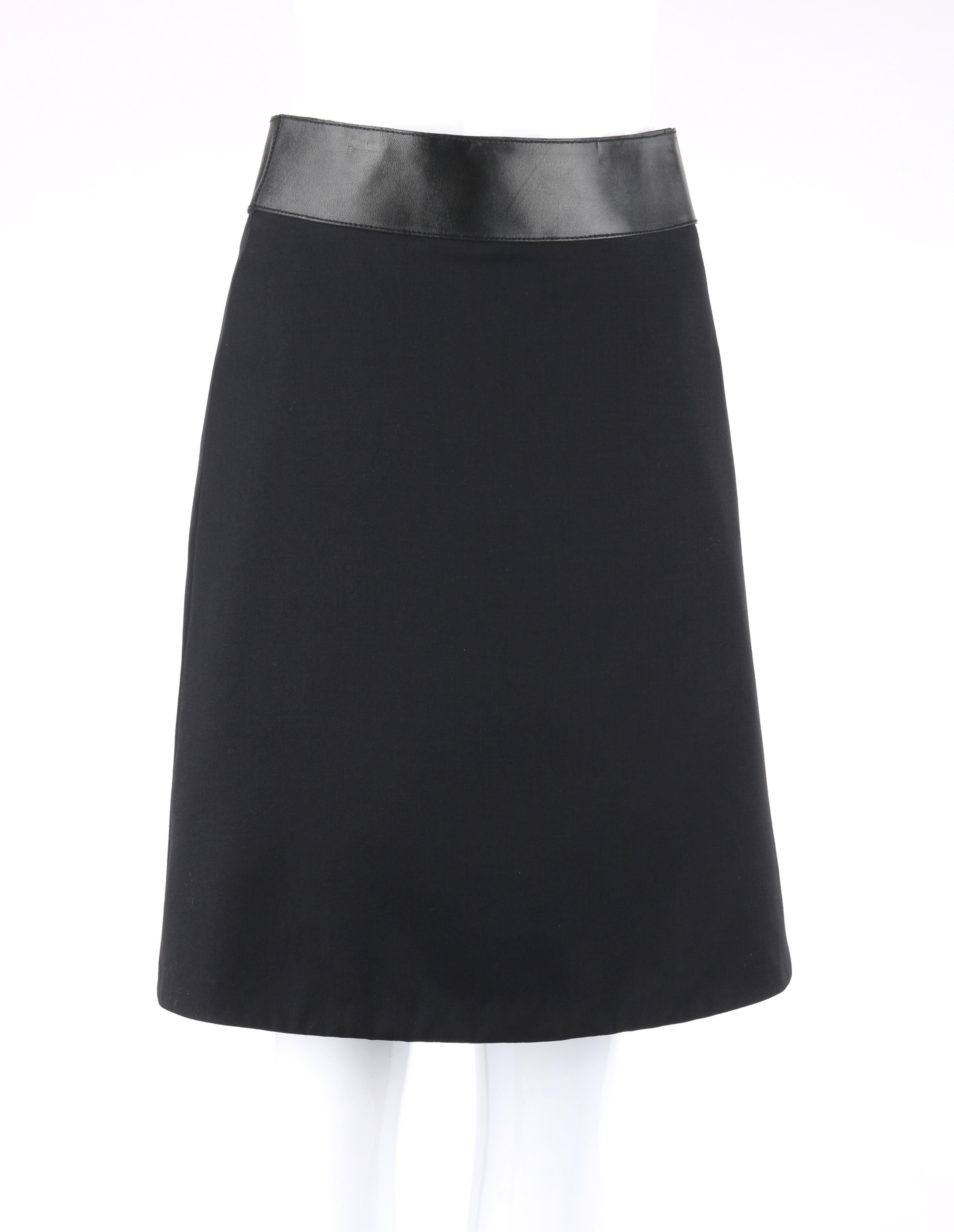 DESCRIPTION: GUCCI Pre-Fall 2014 Black Wool Gabardine Leather Waistband Classic A-Line Skirt
 
Brand / Manufacturer: Gucci
Collection: Pre-Fall 2014
Designer: Frida Giannini
Style: A-line skirt
Color(s): Black
Lined: Yes
Marked Fabric Content: