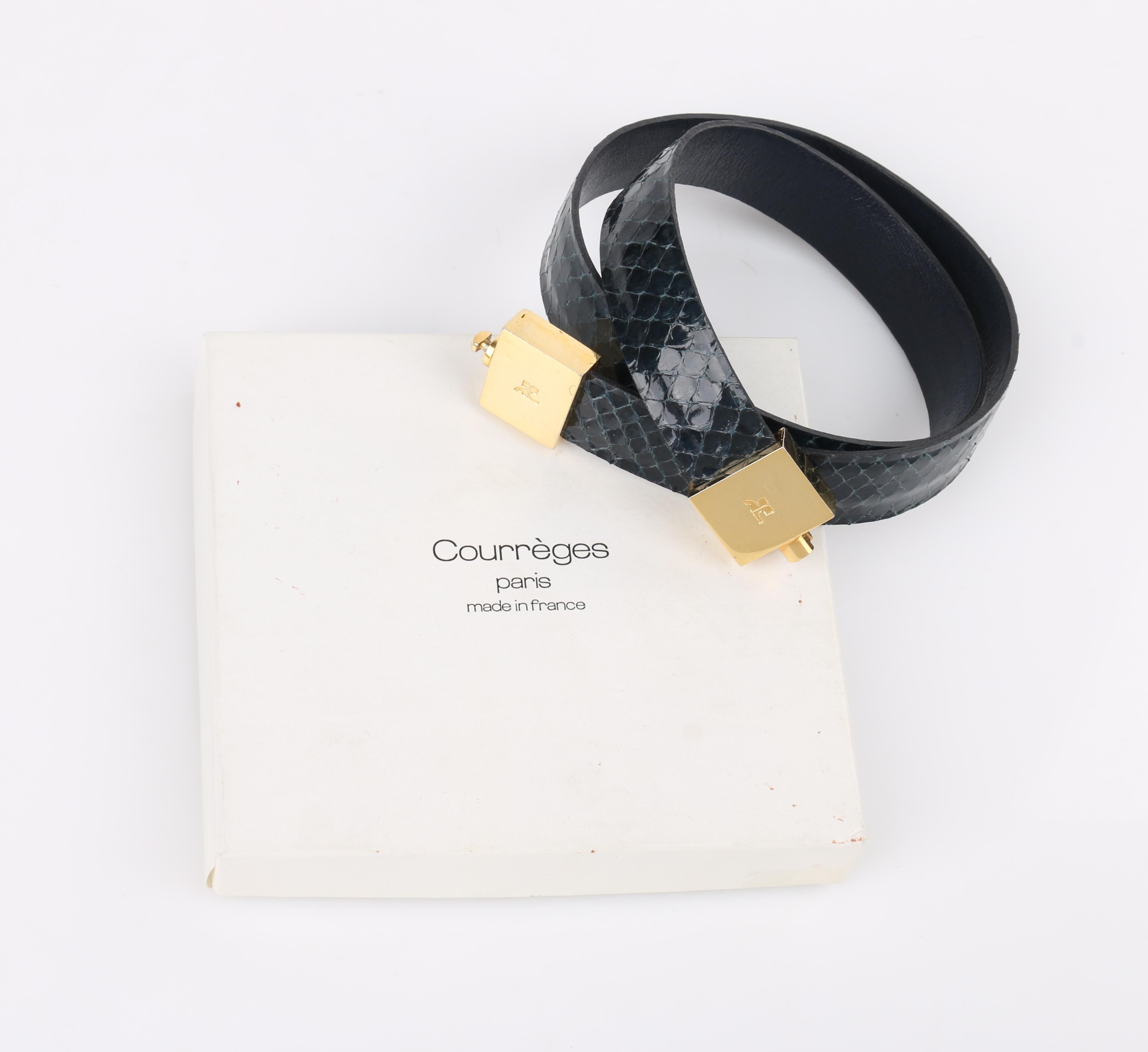 DESCRIPTION: COURREGES Black Patent Snakeskin Leather Turn Lock Closure Waist Belt
 
Circa: Late 20th century
Label(s): 
Style: Waist belt
Color(s): Shades of black; gold-toned metal hardware
Lined: 
Marked Fabric Content: 
Unmarked Fabric Content