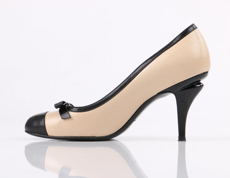 CHANEL Nude and Black Leather Classic Bow Cap Toe Sculptural Heel Pumps at  1stDibs | chanel gray nude, nude and black pumps, chanel nude pumps
