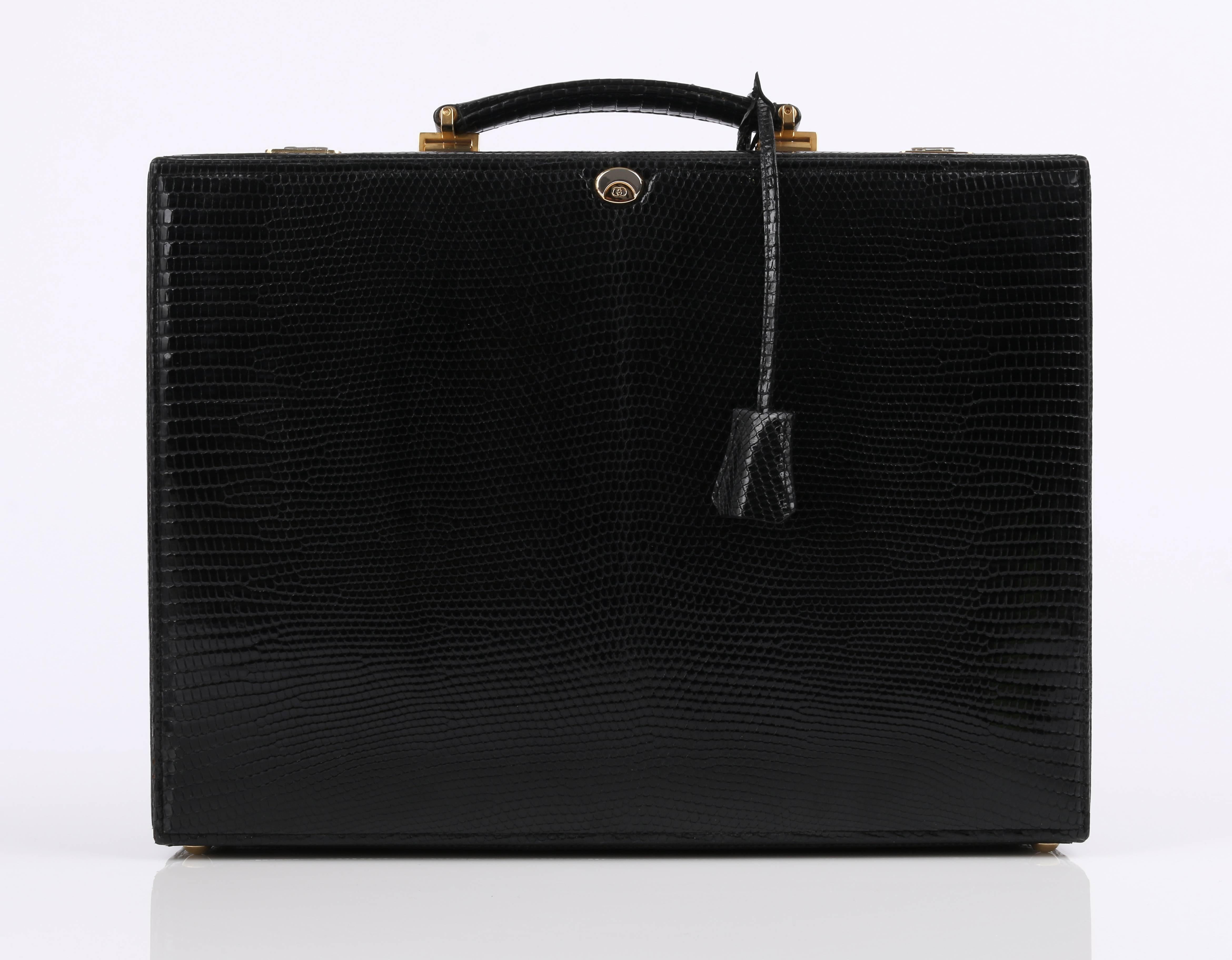 Gucci black lizard leather jewelry briefcase. Black lizard leather handle. Gold tone signature hardware with double locks. Red velvet lined interior. Five removable leather and red velvet trays of varying sizes. Removable red velvet pad at bottom.