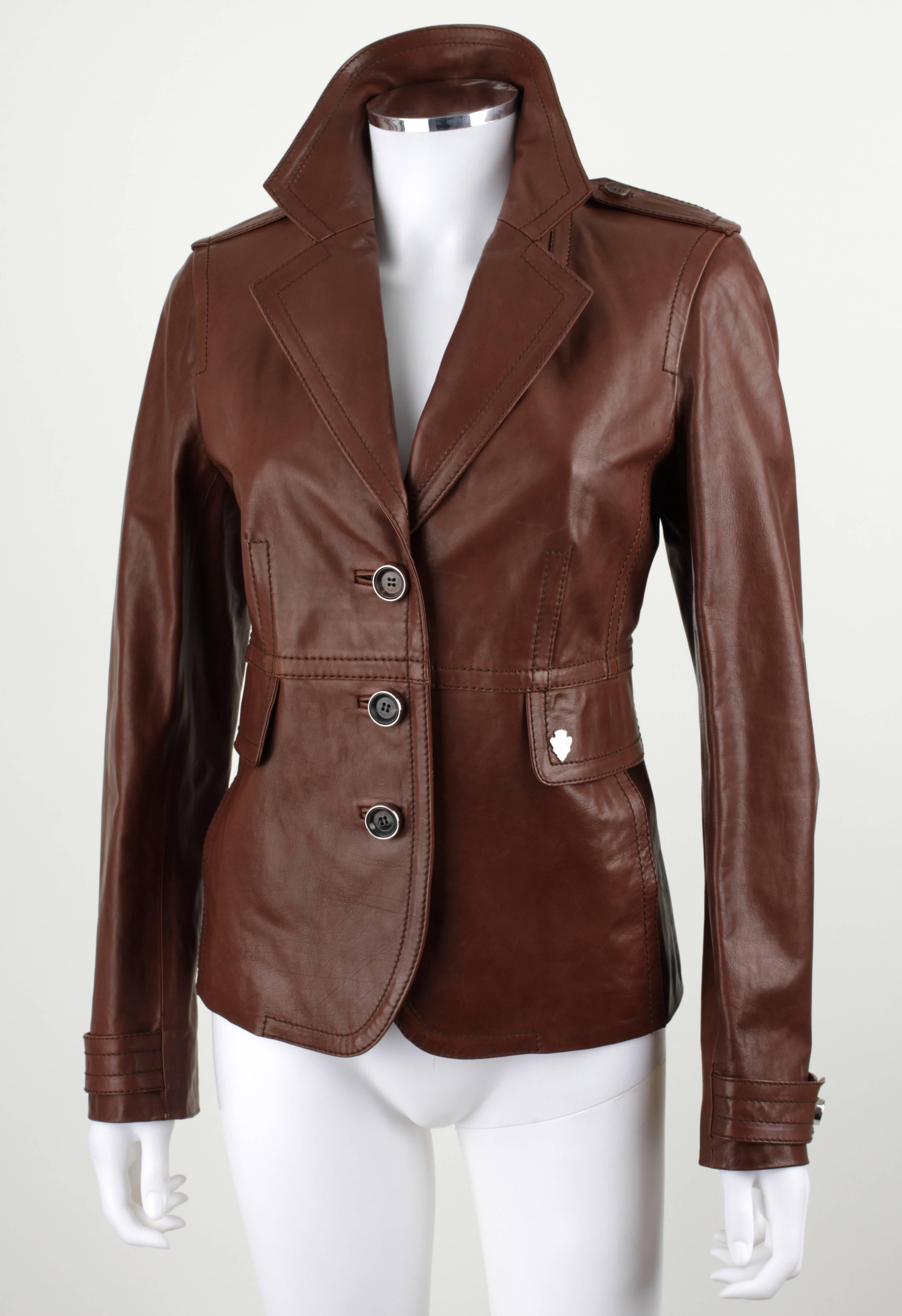 Gucci brown genuine leather jacket. Classic Styling. Button front (3).  Notch lapel. Two faux-pockets. Button detail at cuffs. Silver-tone signature detail. Signature lining.

Measurements & Sizing:

Marked Size: 46 (EU)
Bust: 36 in. (91.44