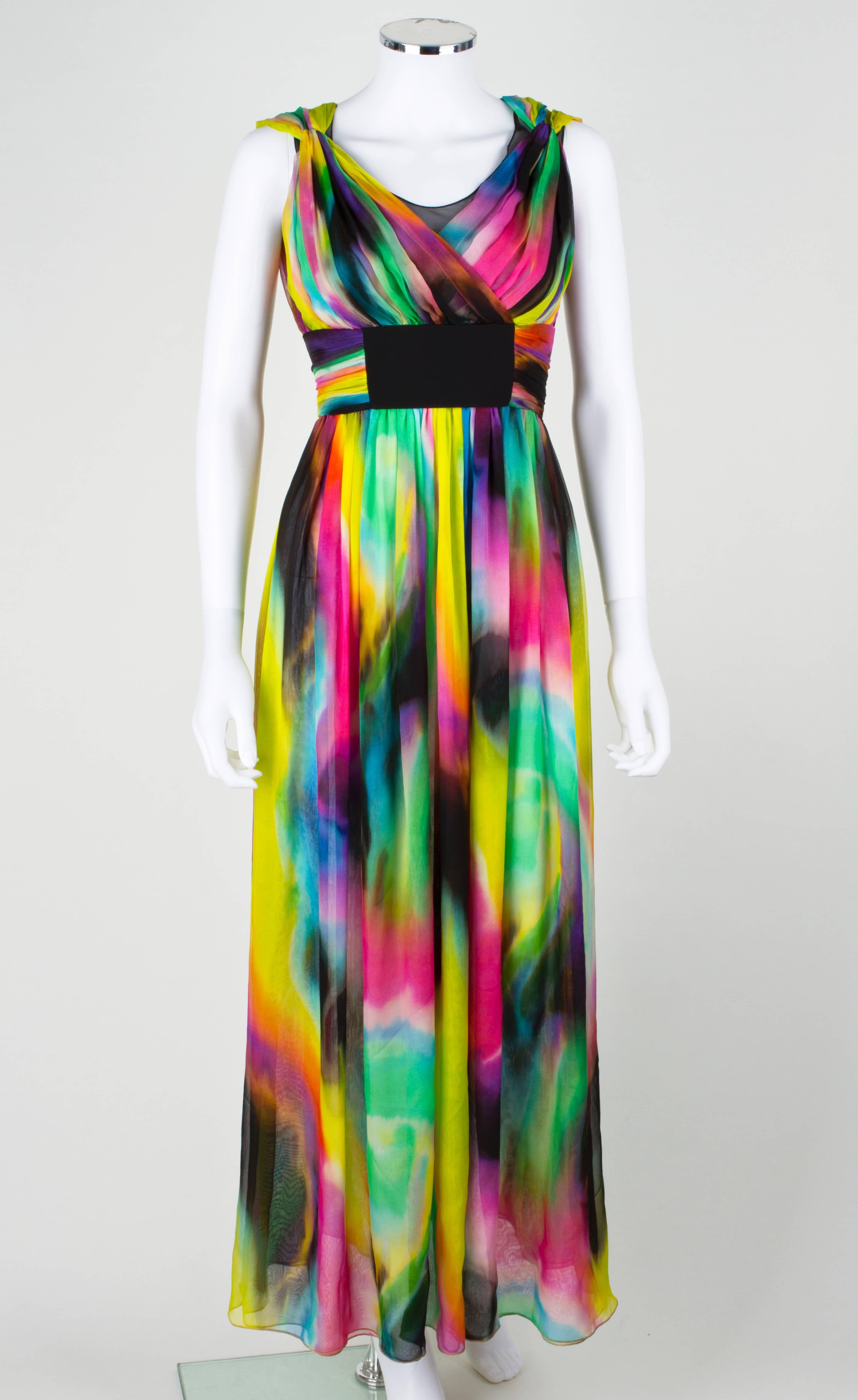Dolce & Gabbana multi-color tie dye silk long gown. High waistline with gathered silk and black stretch material detail. Exposed metal zip closure at back. Bodice is lined in black mesh. From the pre-fall 2008 collection.
Marked Fabric Content: 