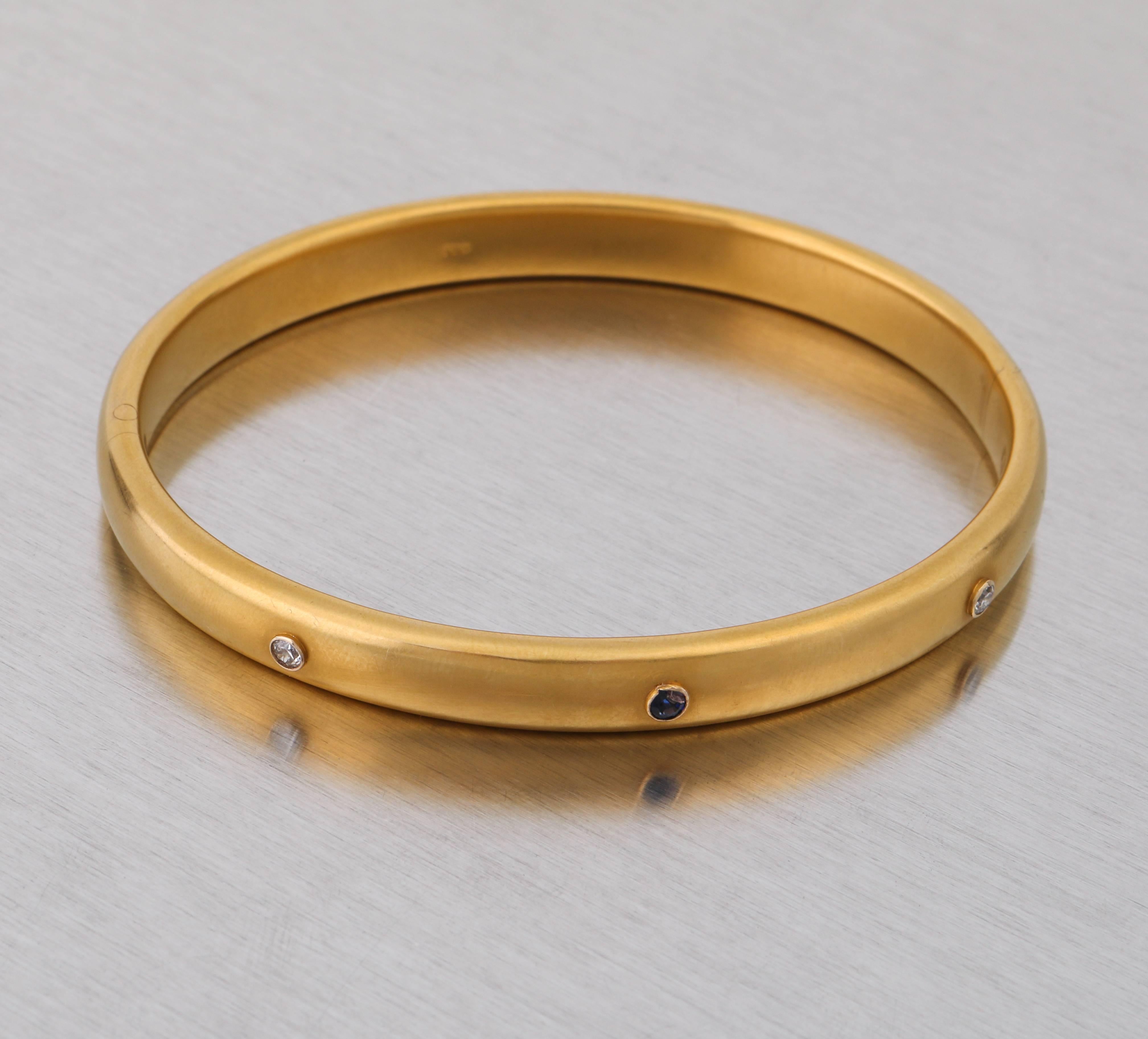 Antique Edwardian c.1900's Greek 14KT gold bangle with 2 round bezel set diamonds and 1 sapphire. Bracelet measures approximately 3